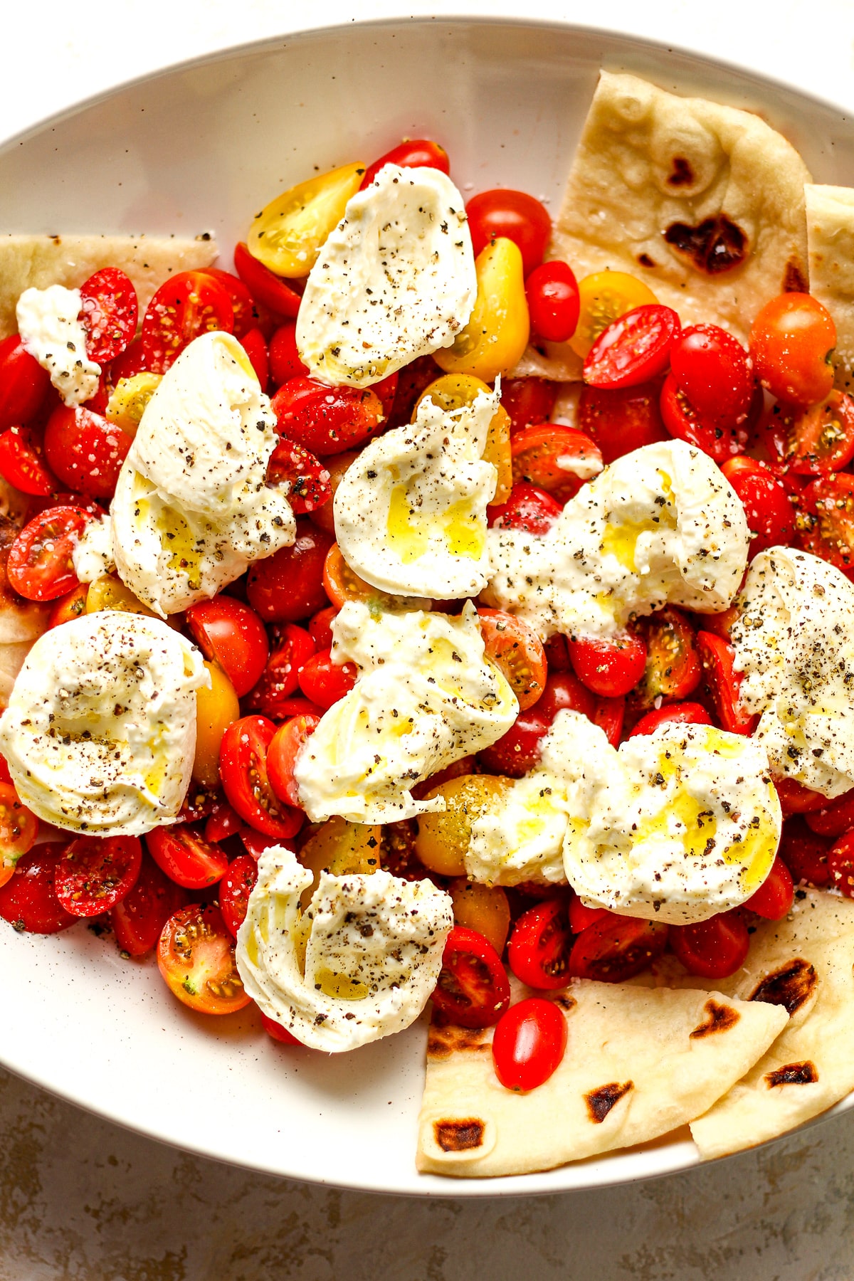 The bowl with cherry tomatoes and burrata cheese.