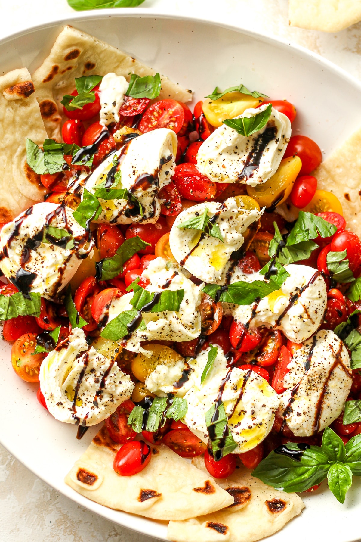 A caprese salad with naan bread.