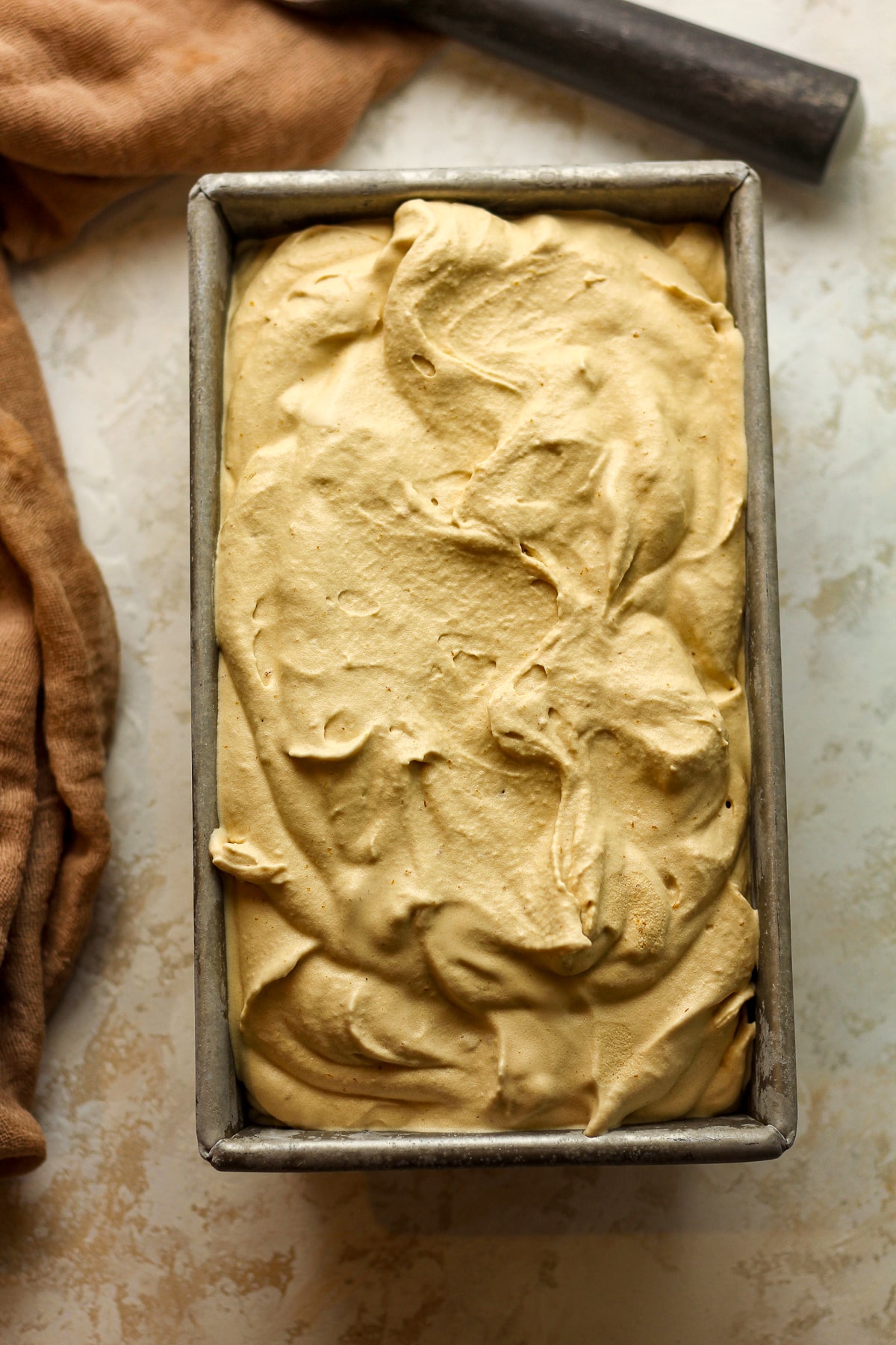 A loaf pan full of butterscotch ice cream.