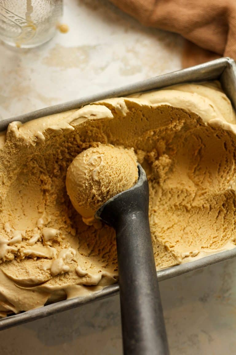 An ice cream scoop with a perfect scoop of ice cream.