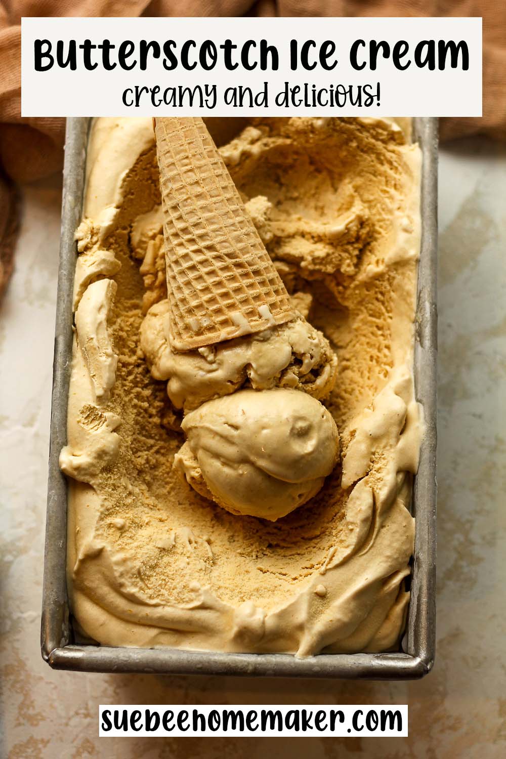 A pan of butterscotch ice cream with a sugar cone.