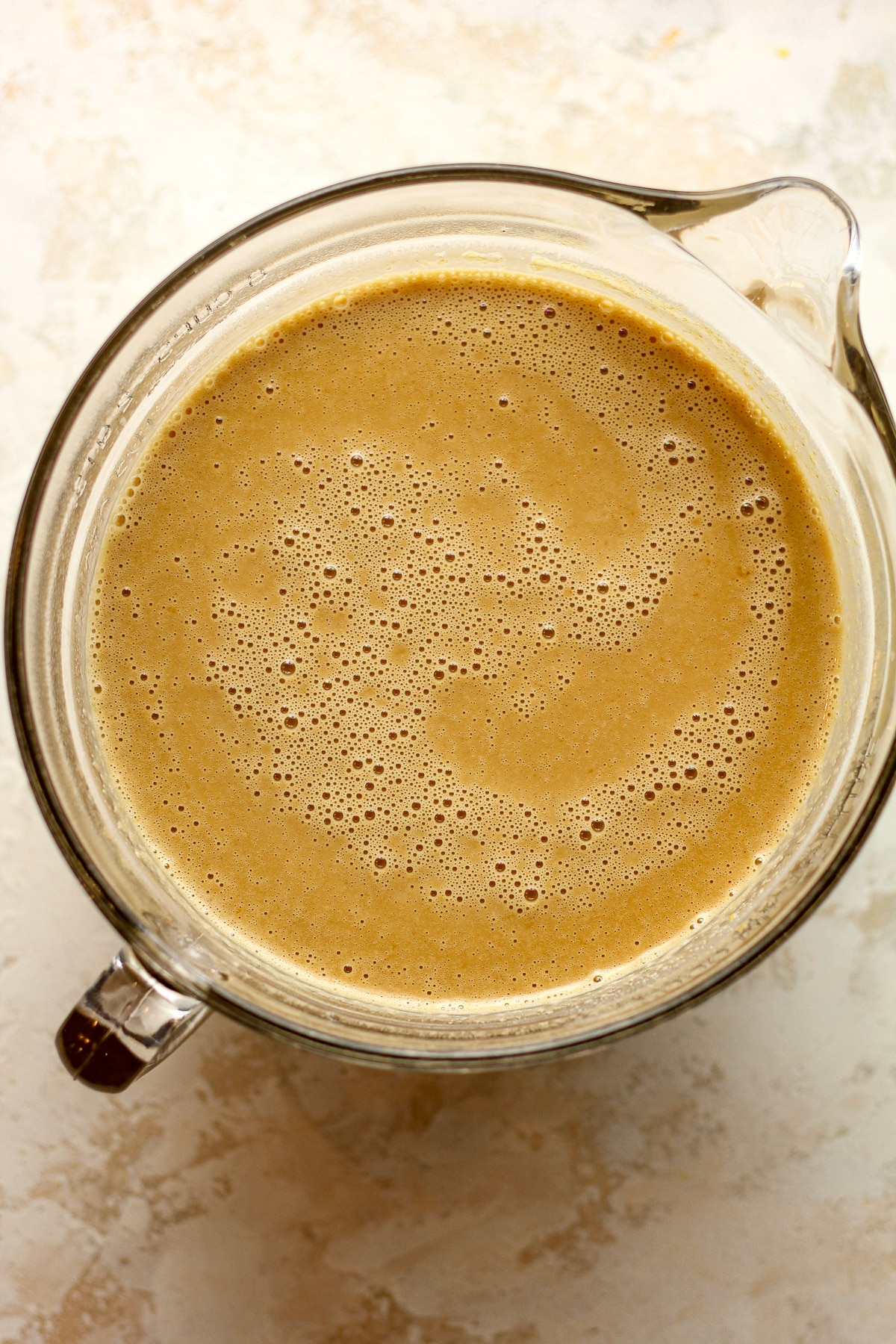 A large measuring cup of the liquid butterscotch ice cream.