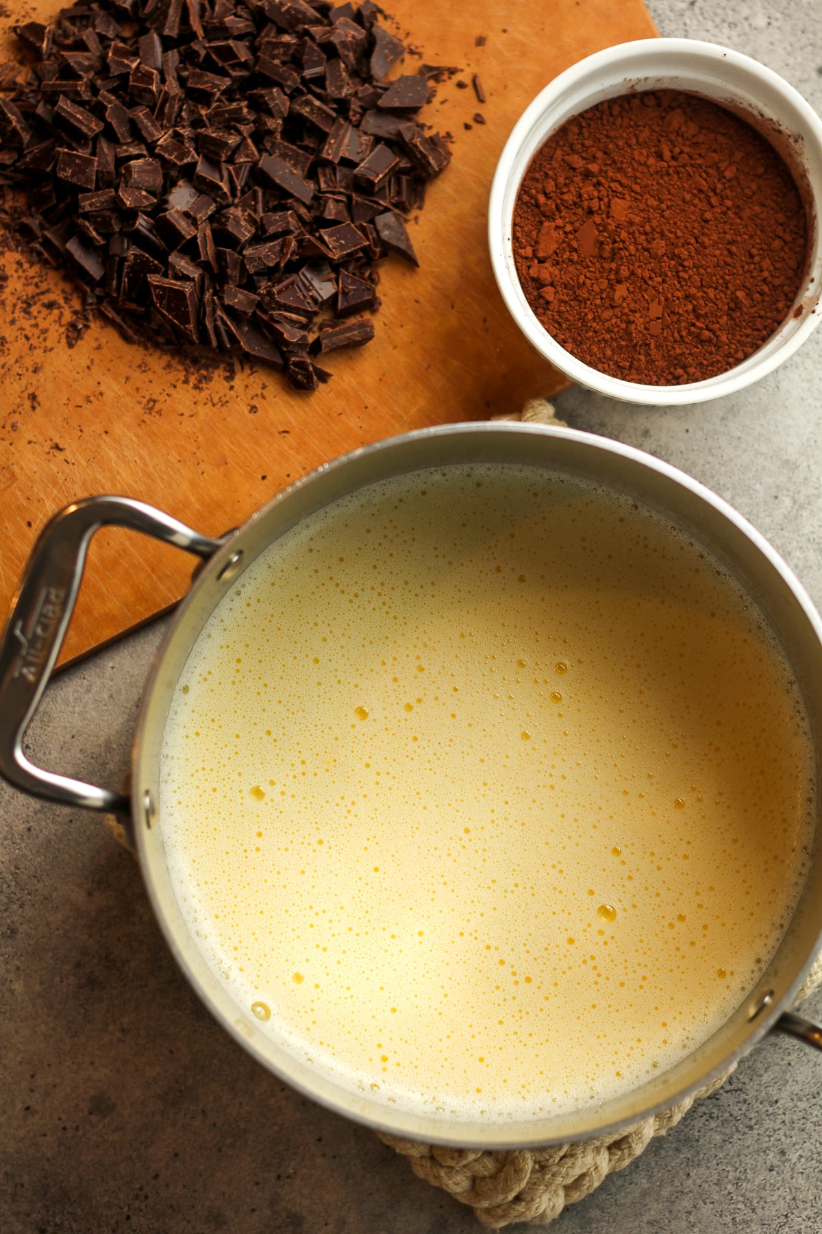 A pot of the tempered eggs and the chocolate beside it.