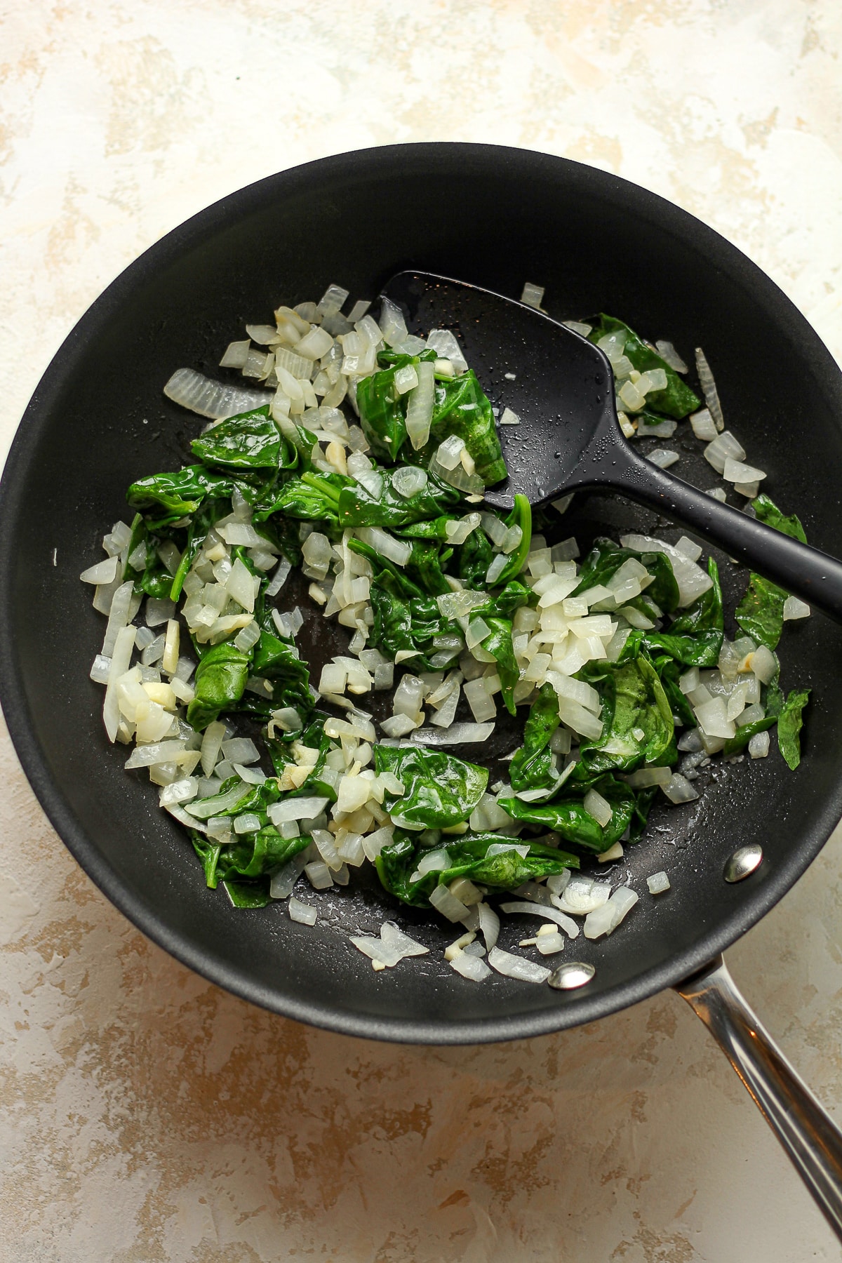 A pan of the sautéed onions, garlic, and spinach.