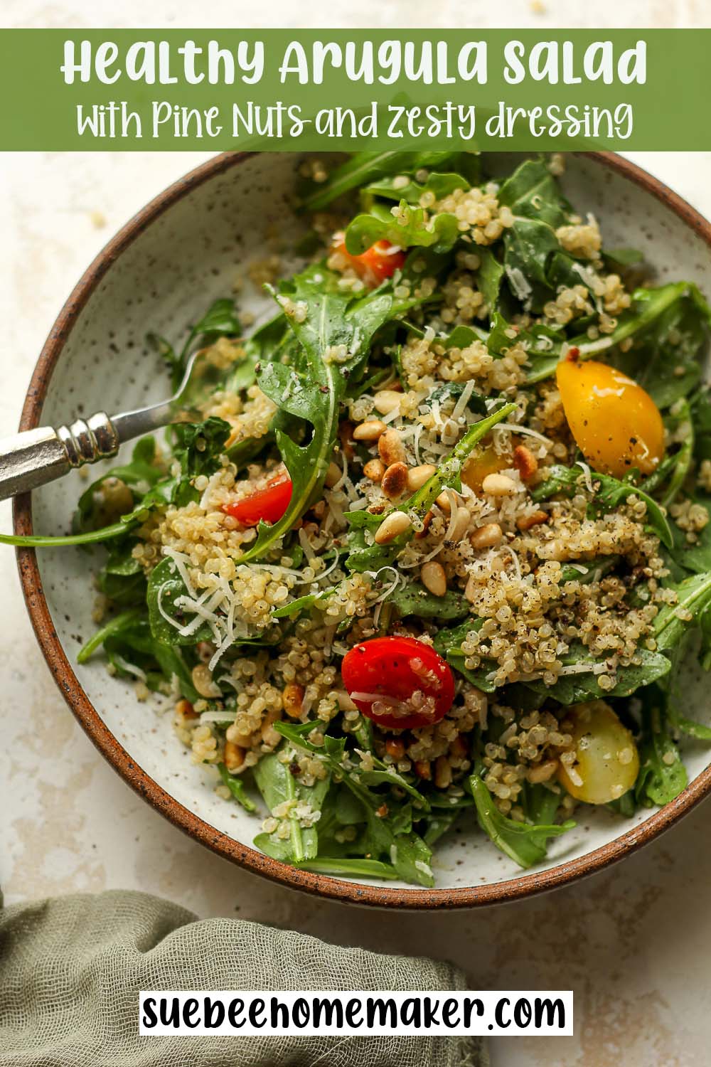 A serving of healthy arugula salad with pine nuts and zesty dressing.