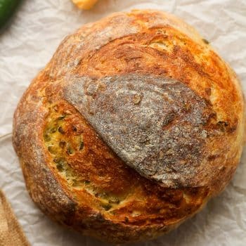 Overhead view of a round loaf of jalapeno cheddar sourdough bread.