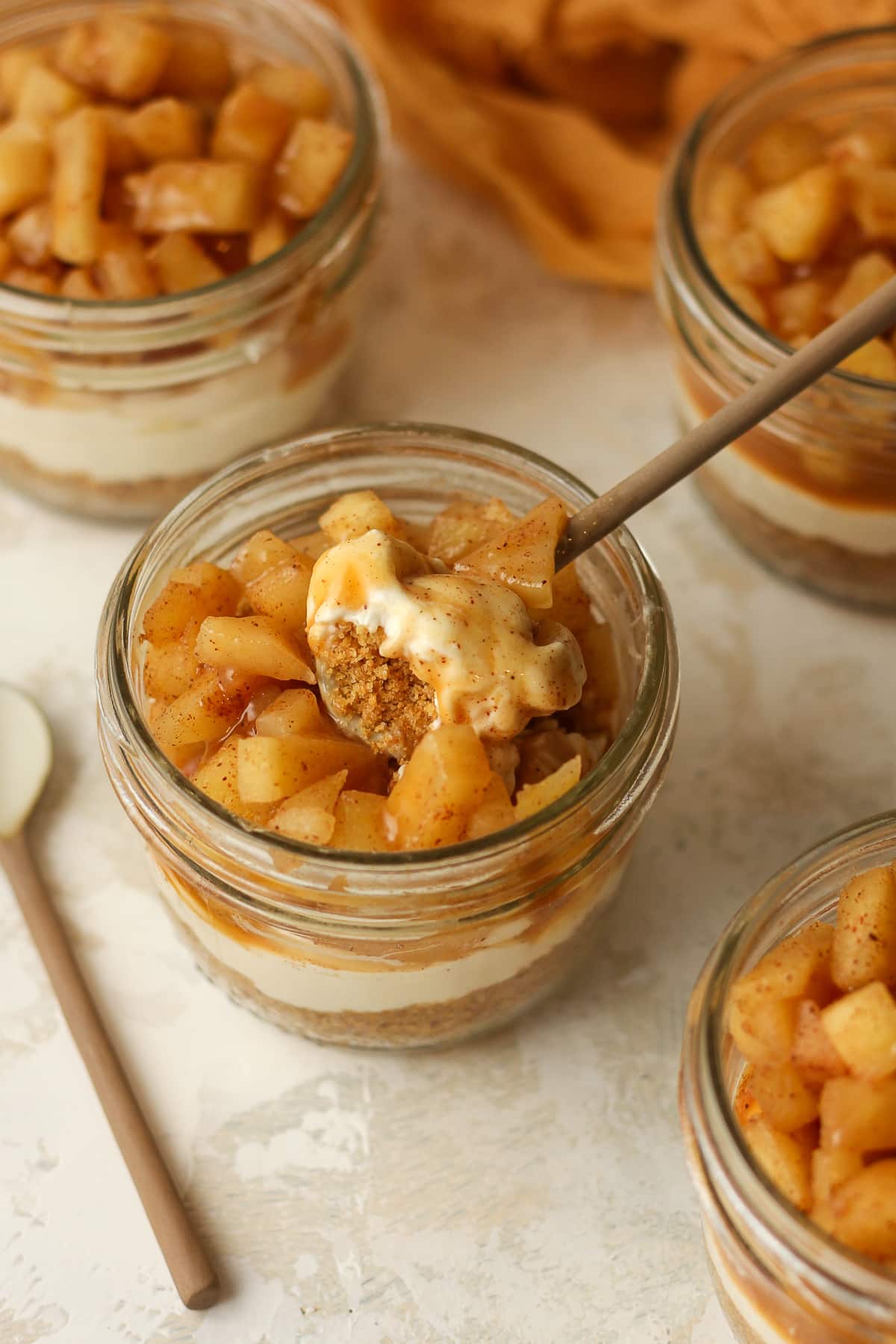 A jar of apple pie with a bite on top.