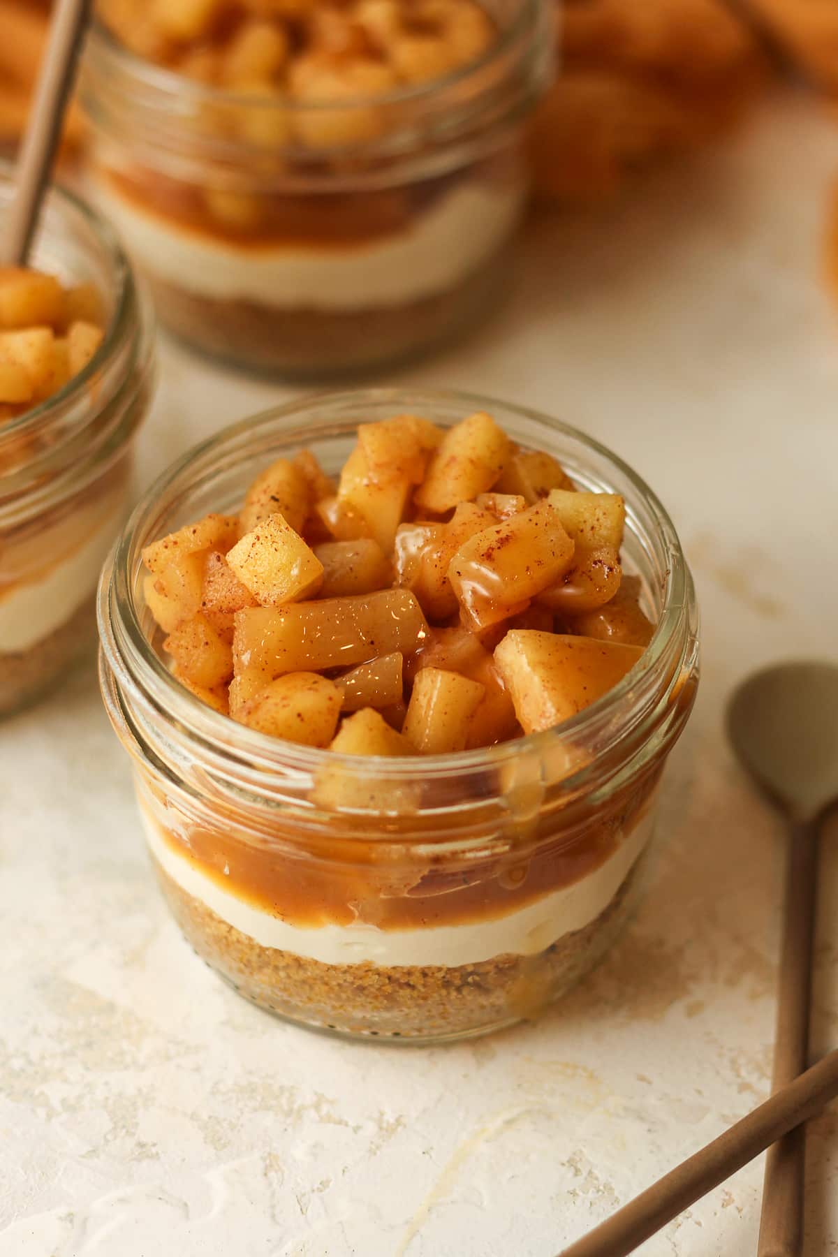 Overhead view of mini apple pies in mason jars.