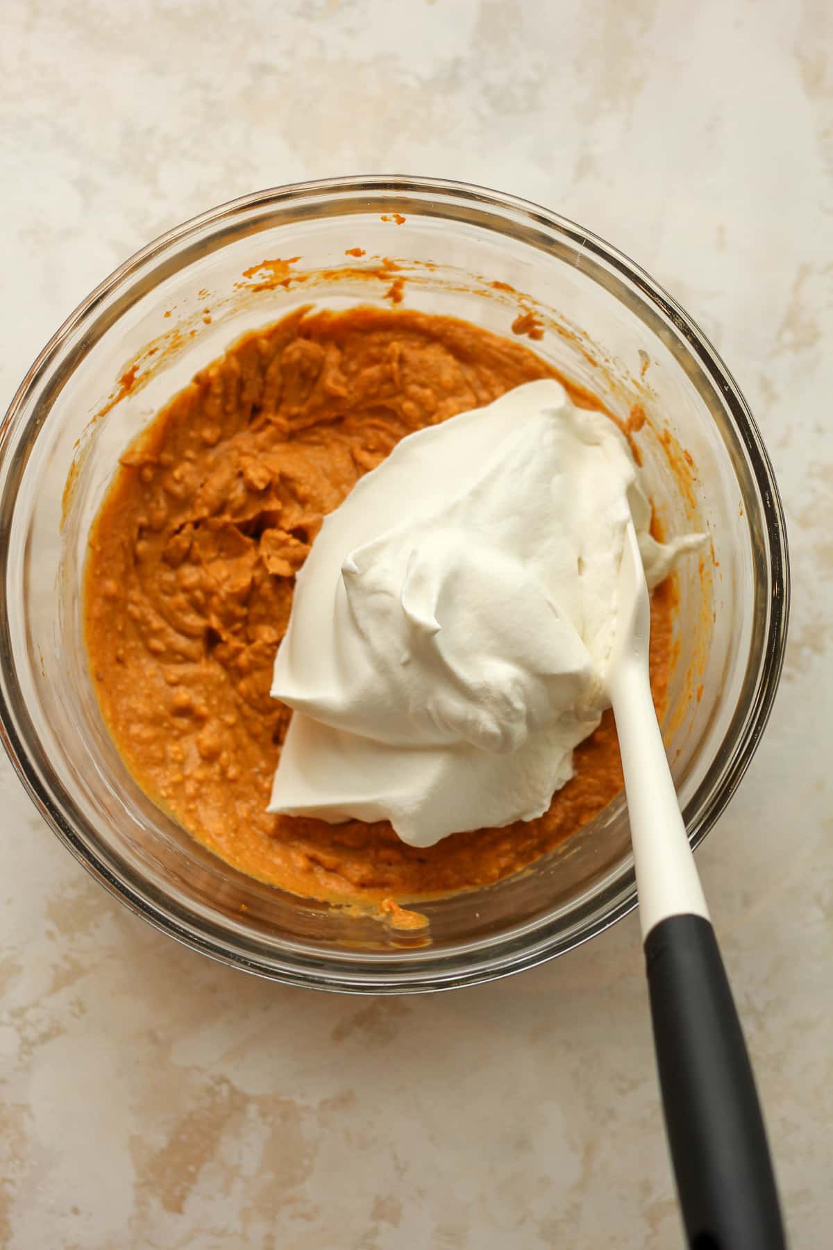 A bowl of the pumpkin mixture with cool whip on top.