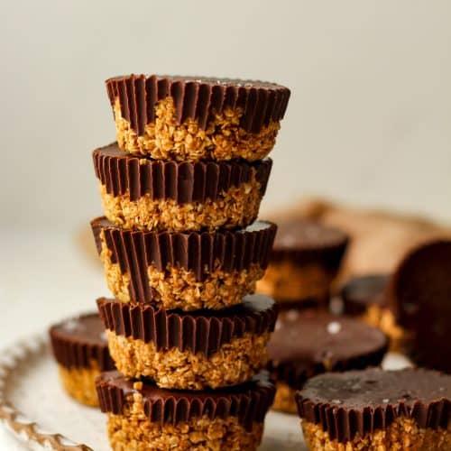 A stack of five peanut butter oat cups on a plate.