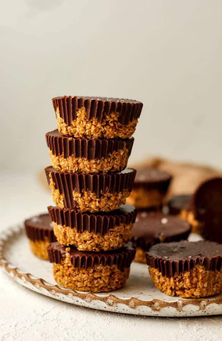 A stack of five peanut butter oat cups on a plate.