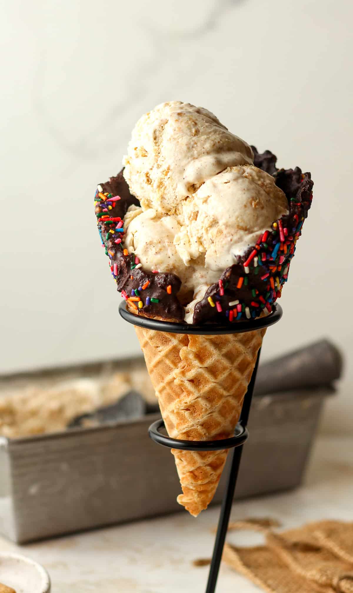 Side view of a waffle cone of graham cracker ice cream.