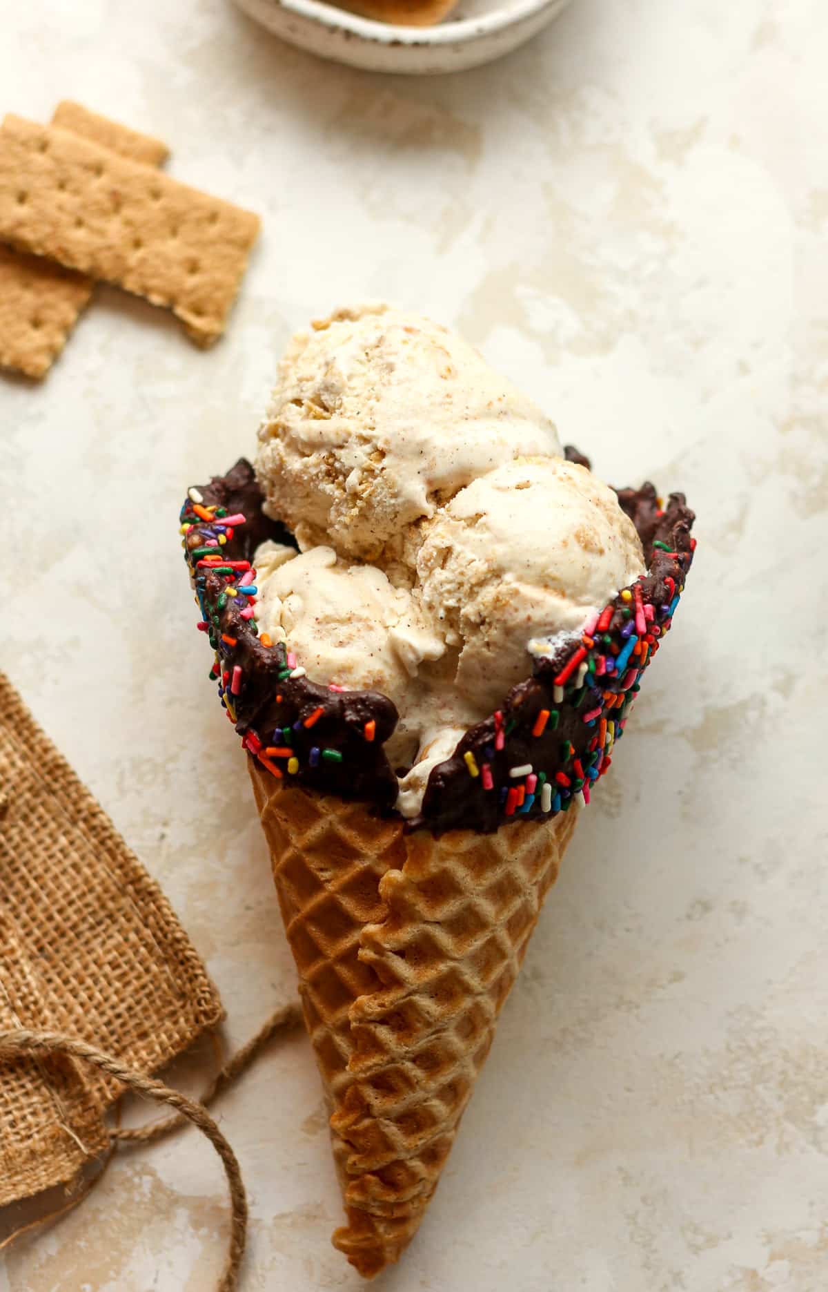 A waffle cone filled with scoops of cinnamon ice cream.