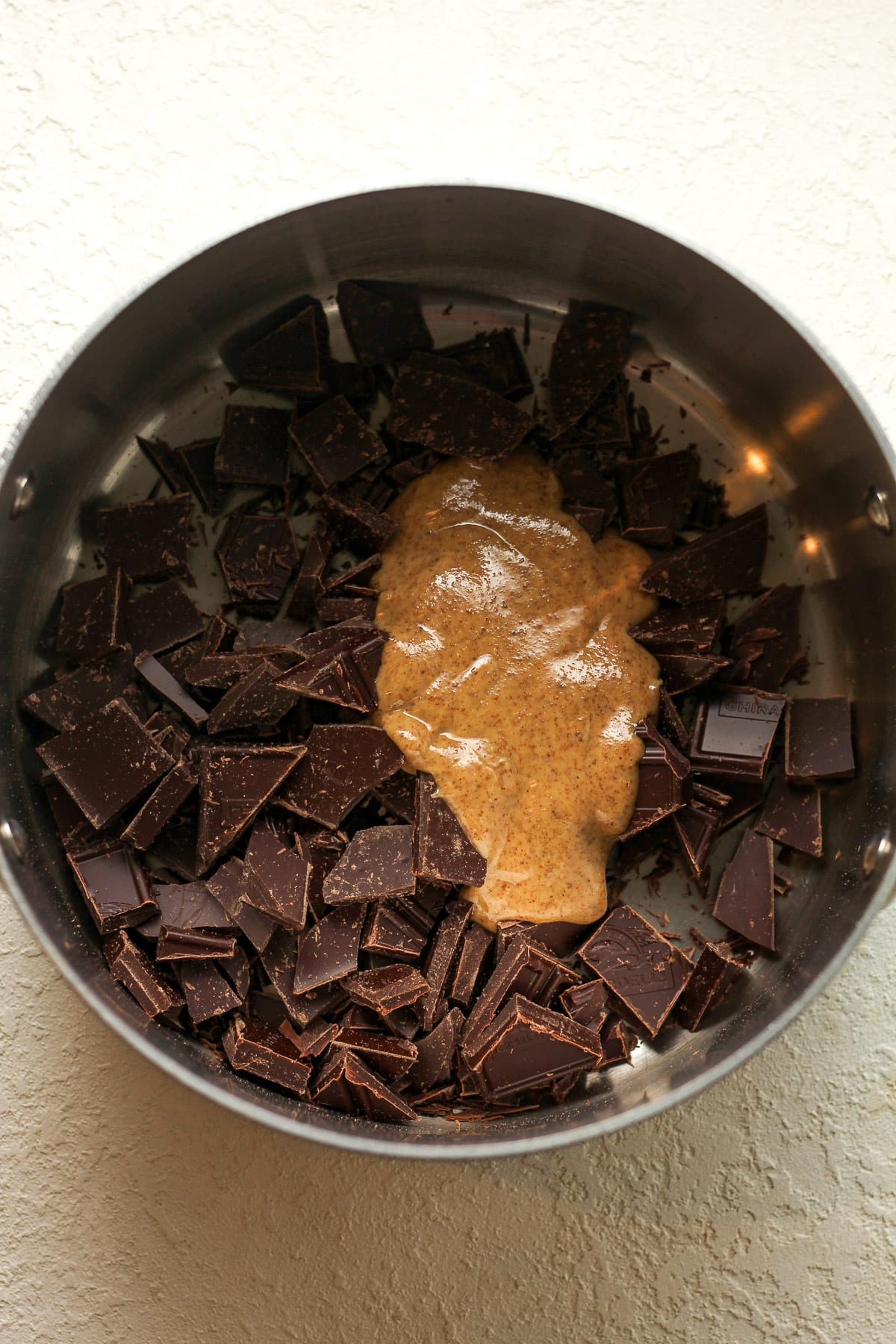 A pan of the chopped chocolate plus almond butter.