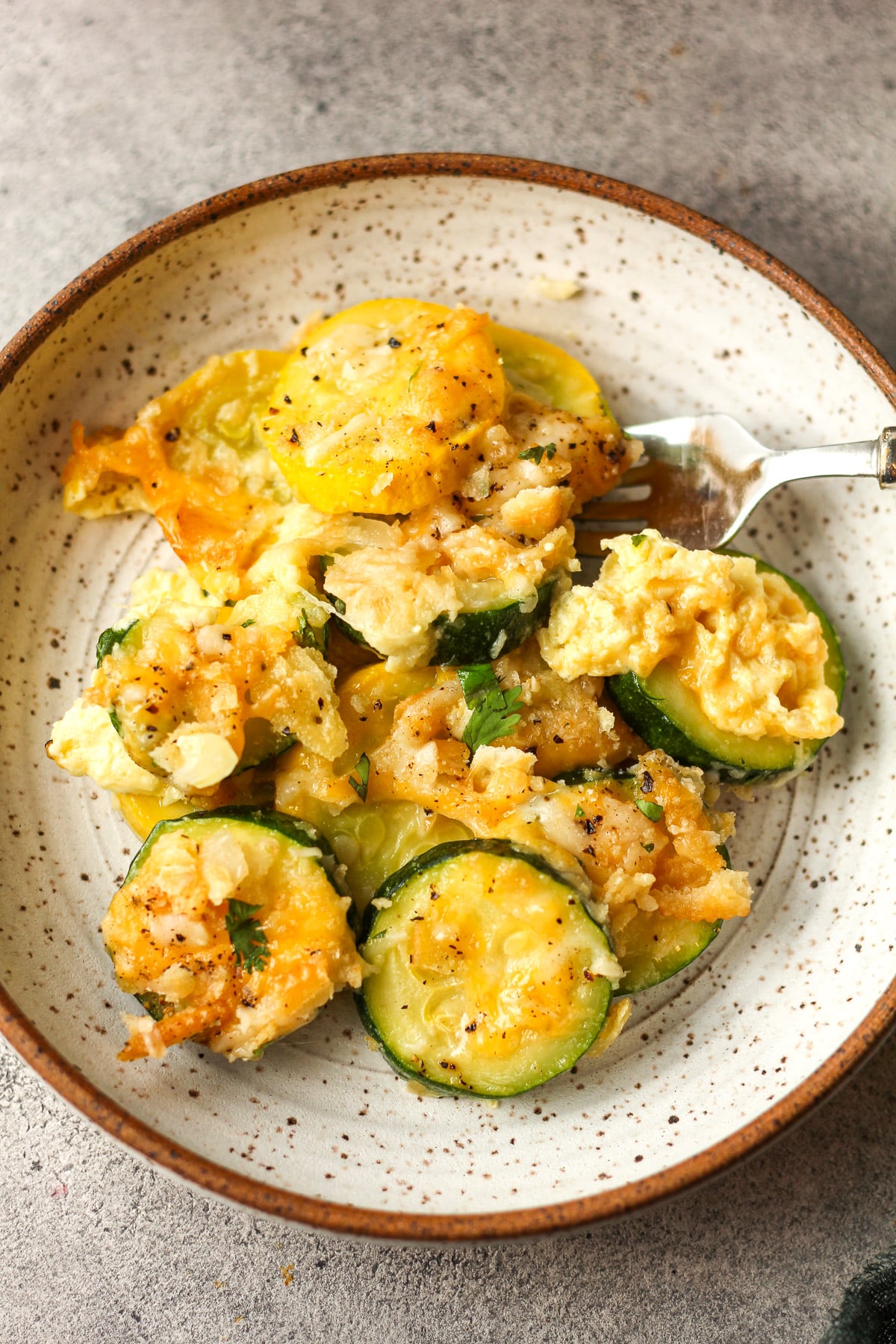 Closeup on a serving of the squash casserole with ritz cracker topping.