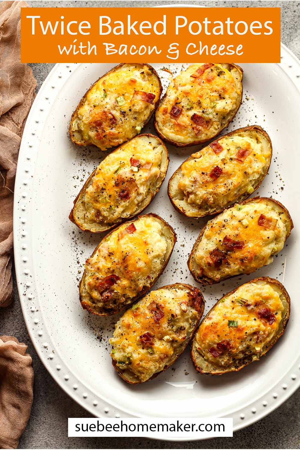A large platter of twice baked potatoes with bacon and cheese.
