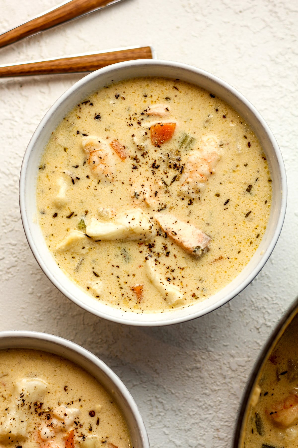 Overhead view of two bowls of seafood chowder.