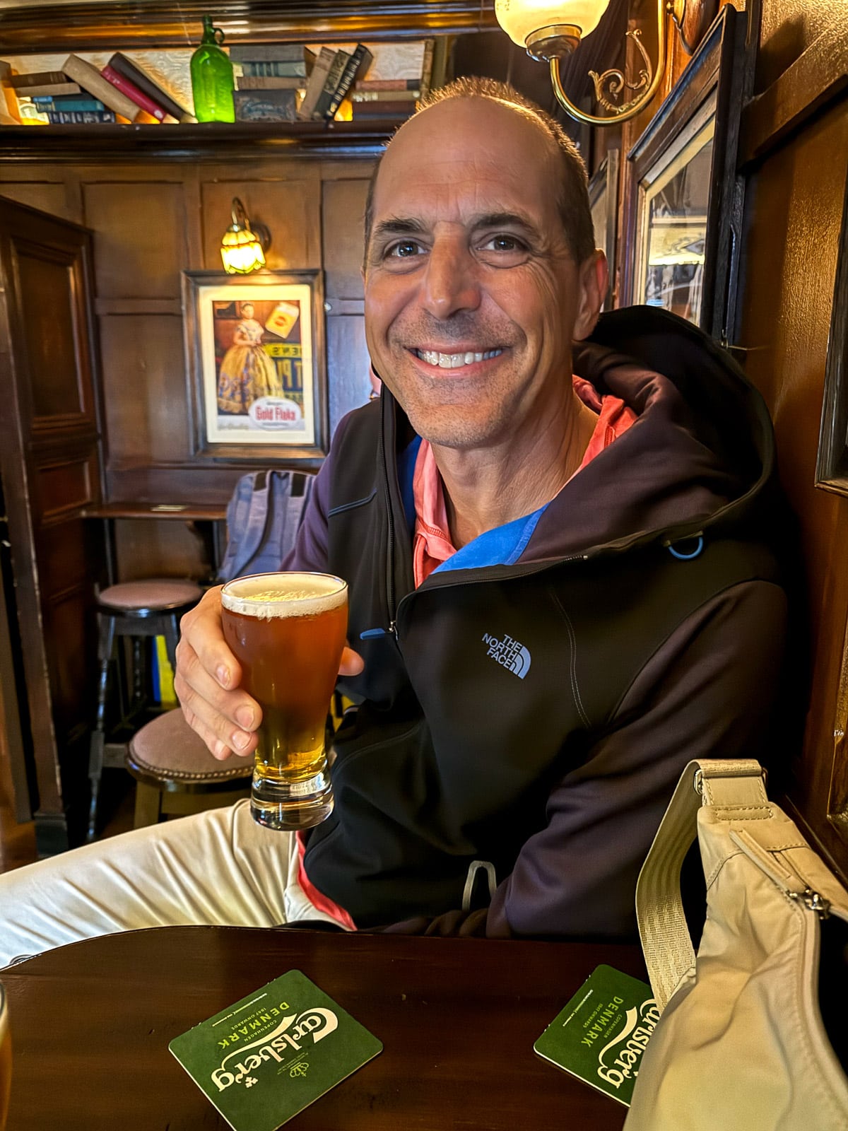 Mike sitting in a pub drinking a beer.