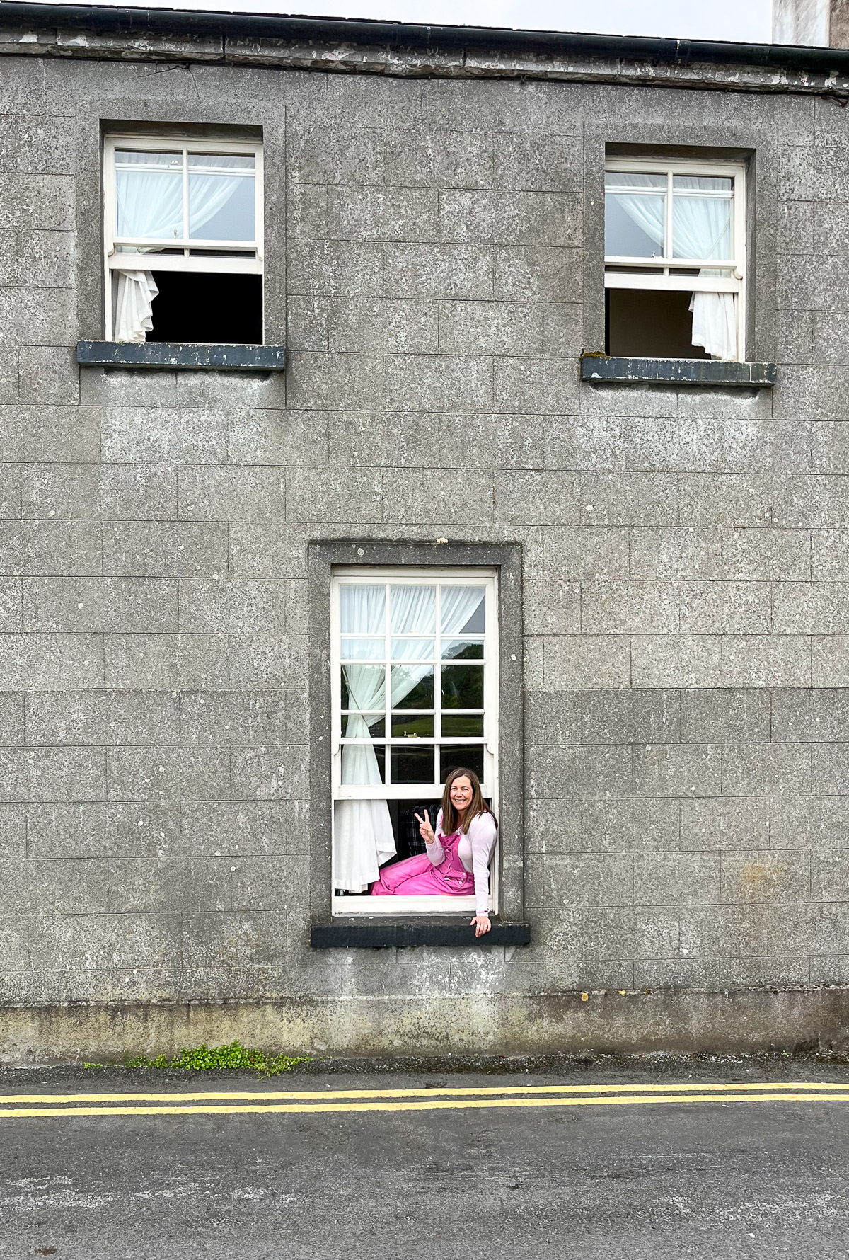 A gray airbnb and me sitting on a windowsill.