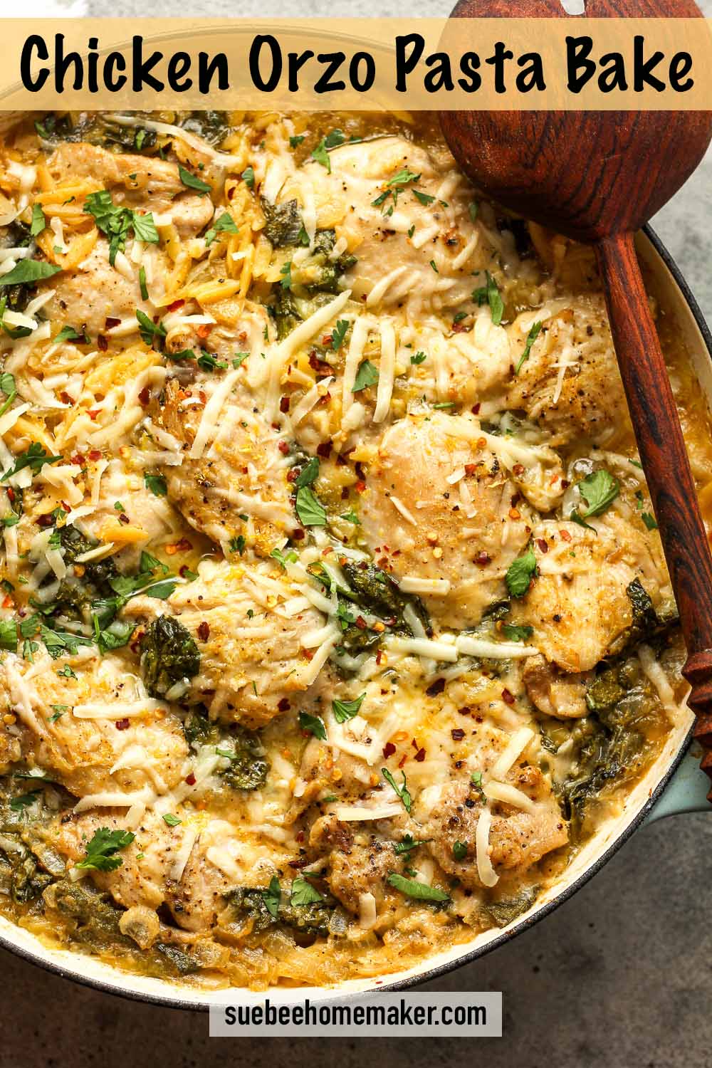 A pot of Chicken Orzo Pasta Bake with wooden spoons.