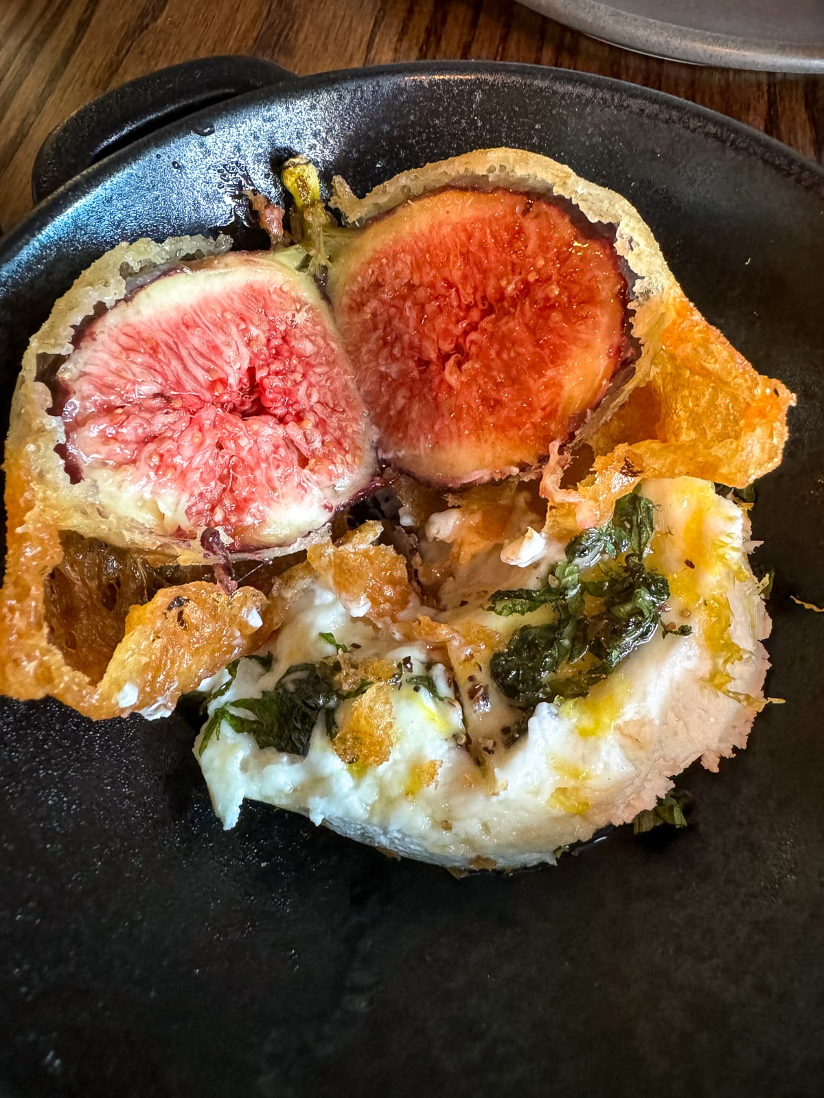 A plate of fried fig and goat cheese.