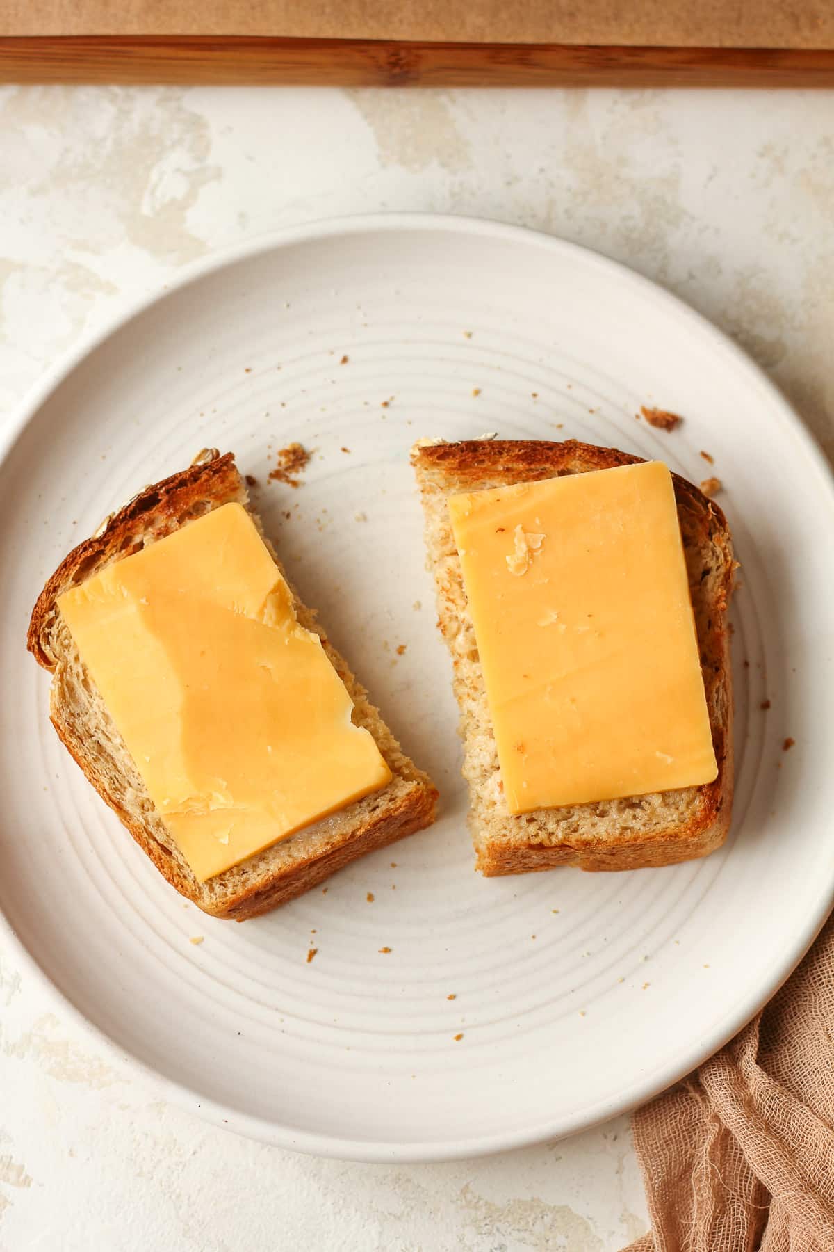 A piece of toasted oatmeal bread with cheese.