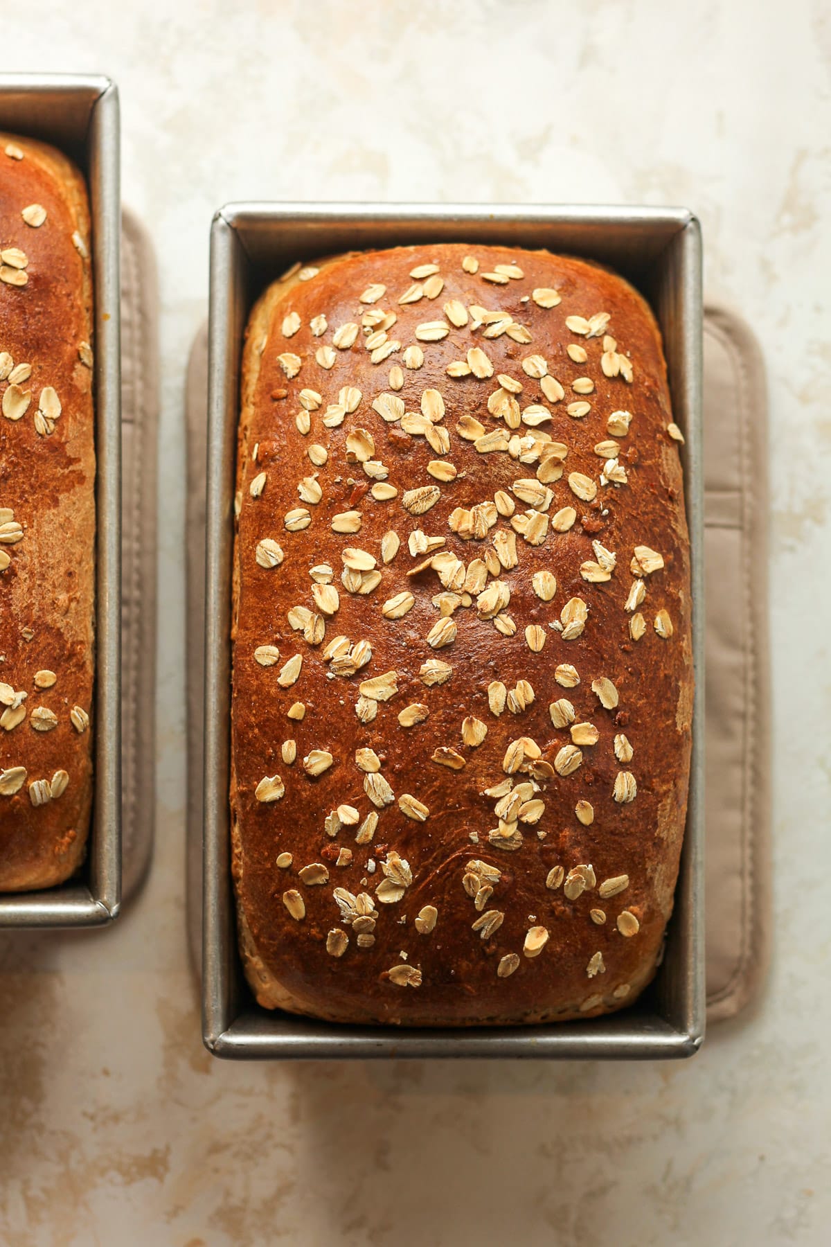 Two loaves of baked oatmeal bread.