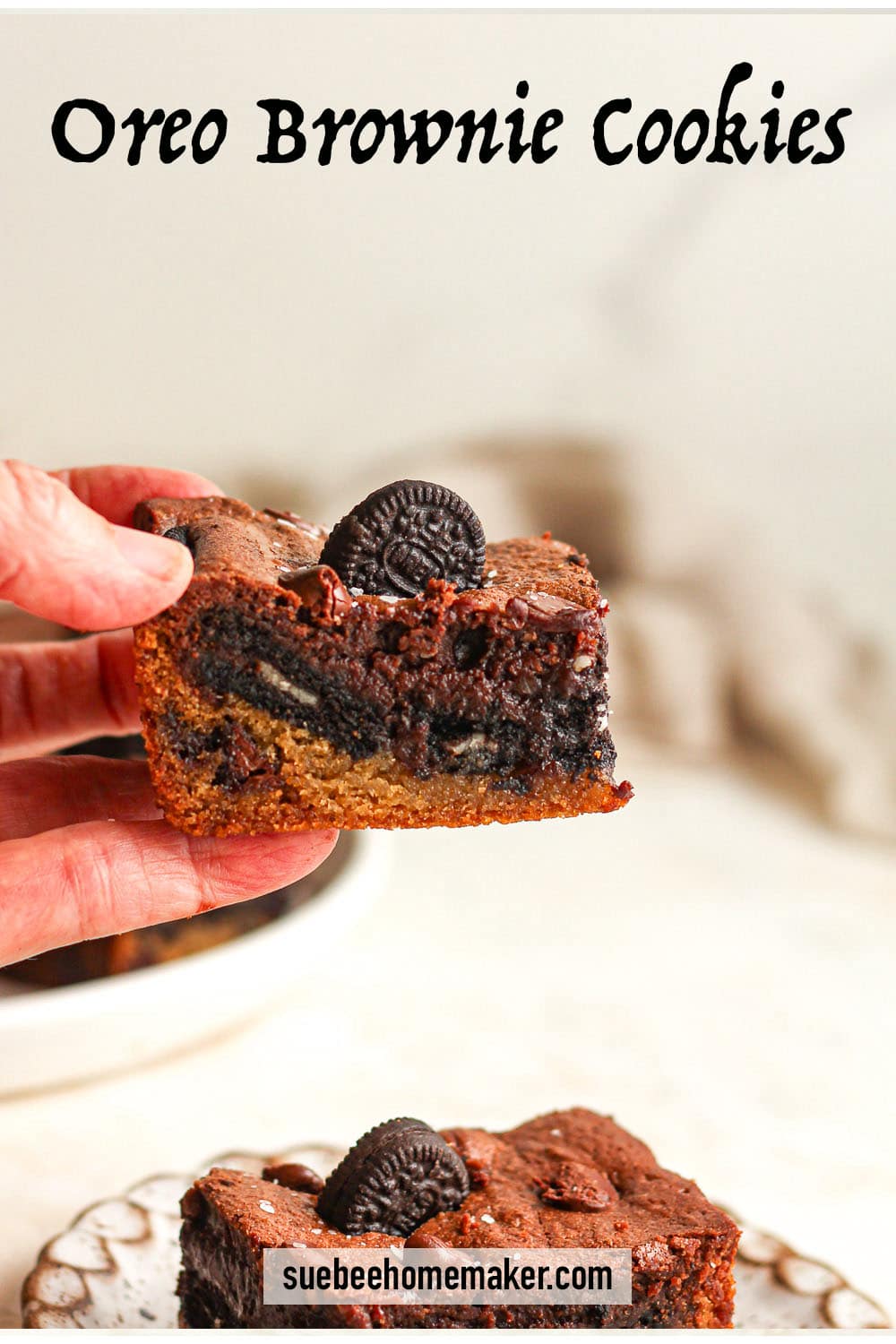 Side view of a hand holding a Oreo Brownie Cookie.