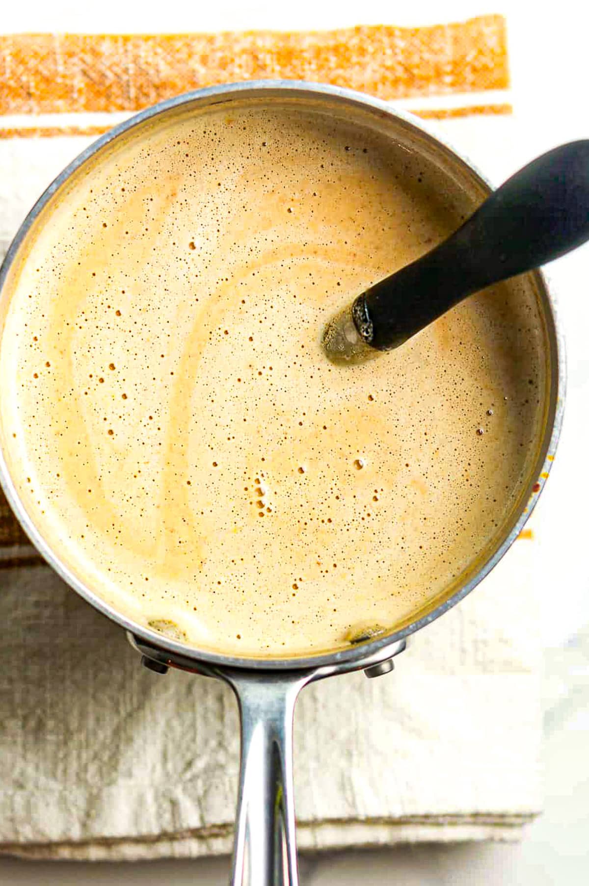 A pan of the liquid ingredients after tempering eggs.