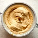 A KitchenAid ice cream attachment full of creamy pumpkin ice cream.