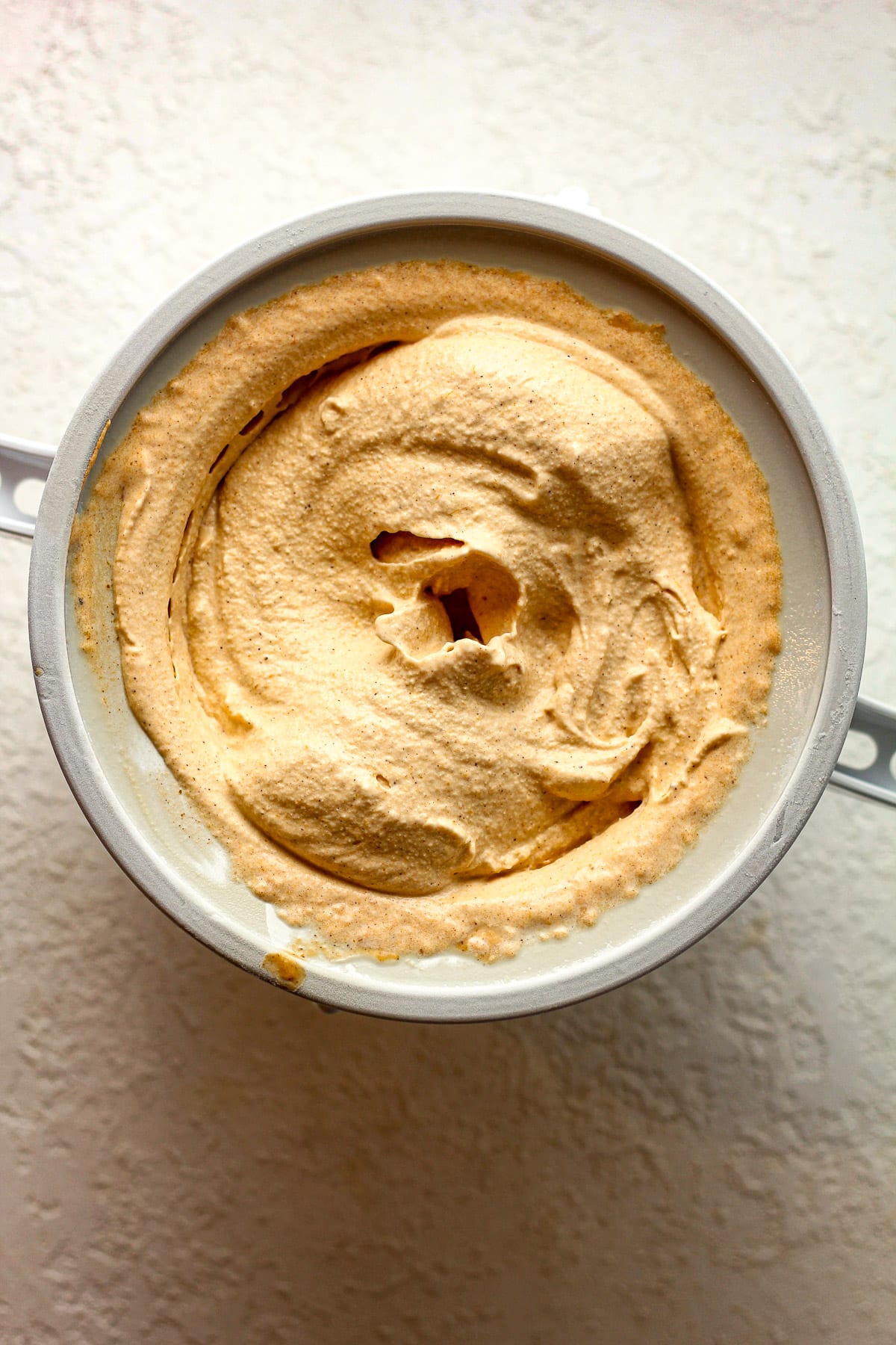 A KitchenAid attachment with churned pumpkin ice cream.