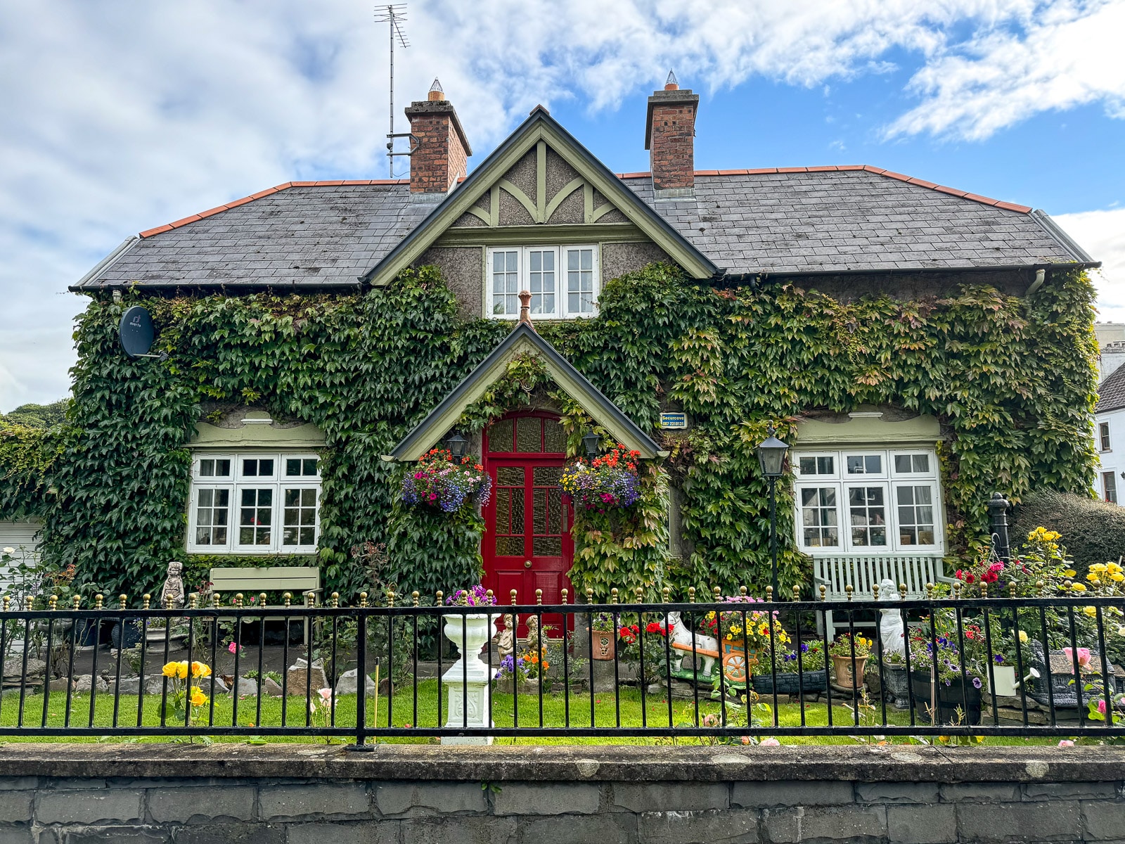 A home in Westport with greenery and flowers all over the front.