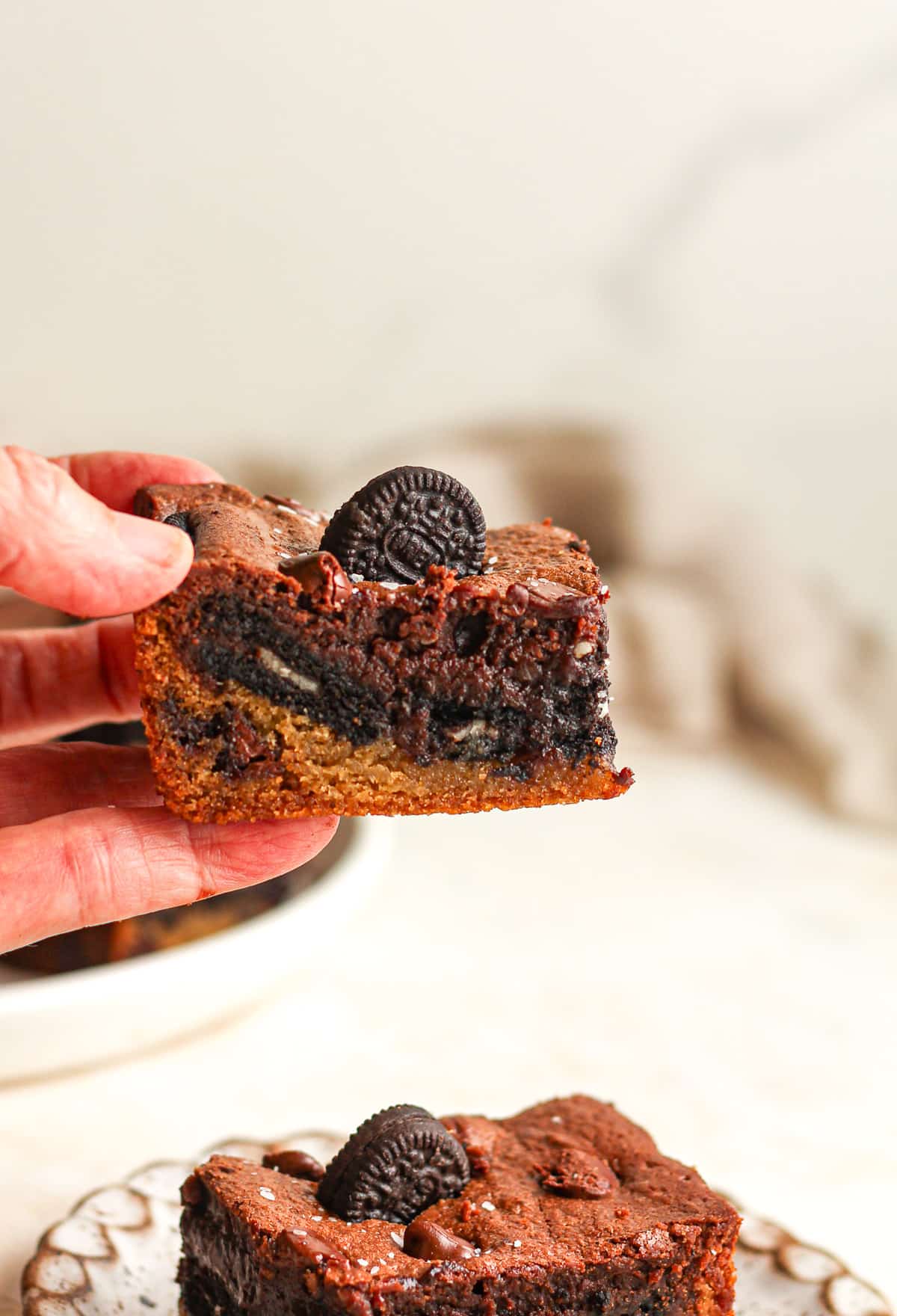 My hand holding an Oreo cookie brownie.