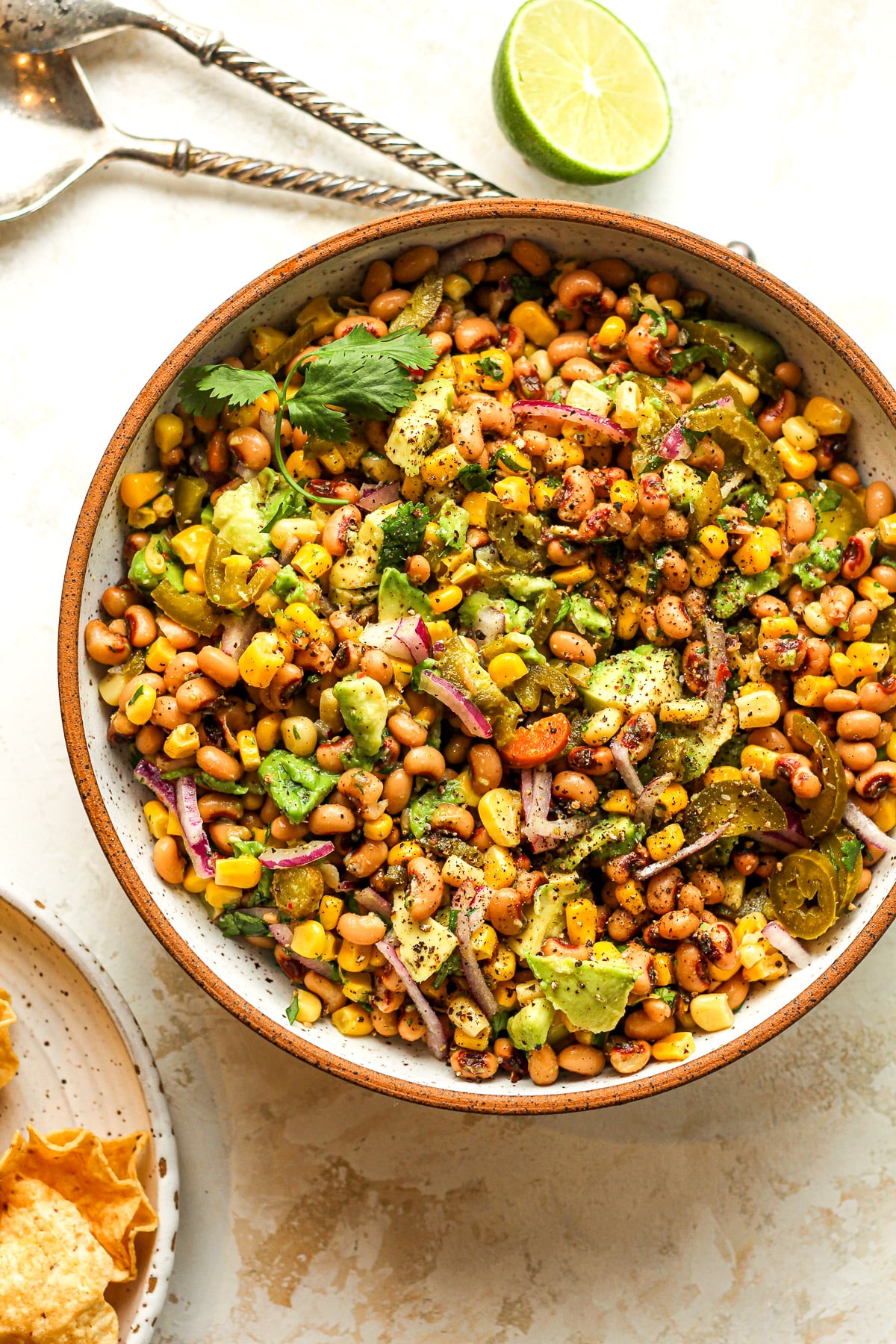 A bowl of black eyed pea dip with lime juice.