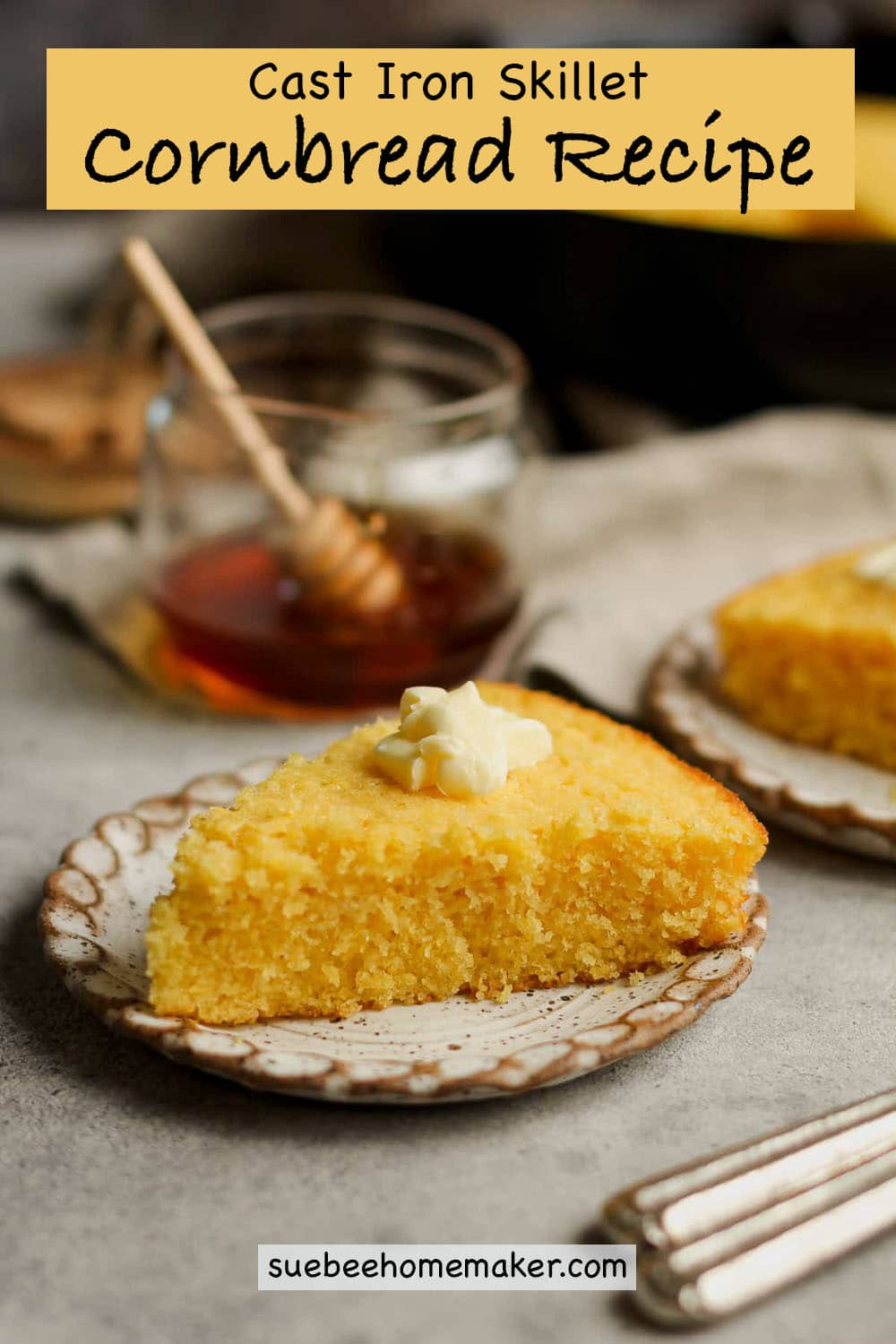 Side view of a slice of cast iron skillet cornbread with butter on top.