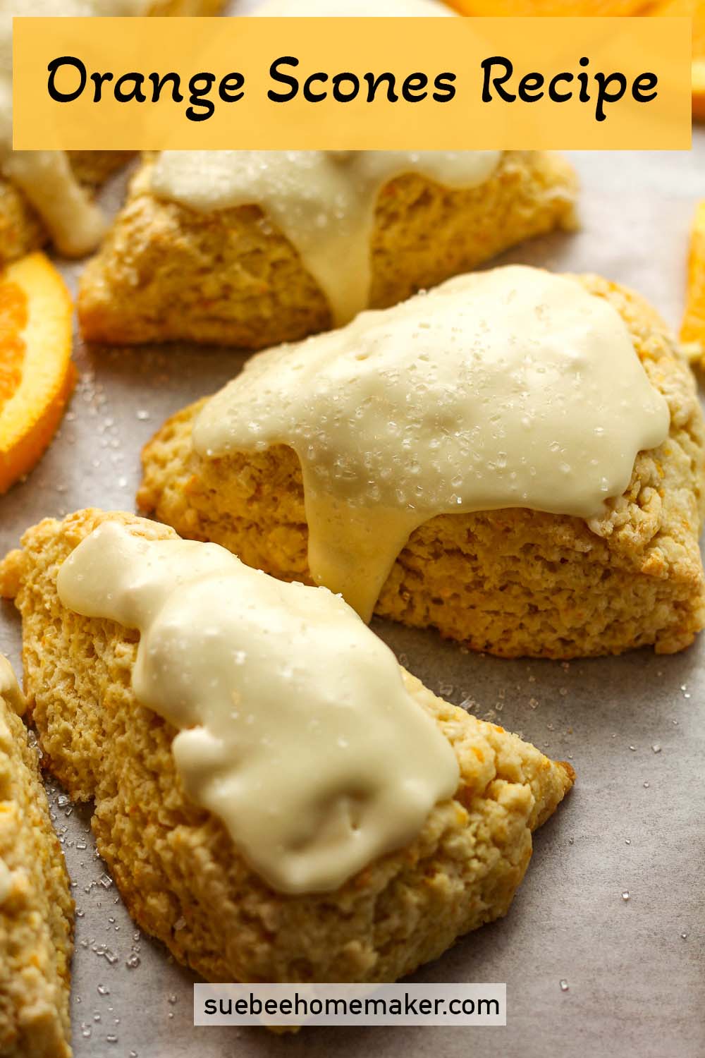 Closeup view of some orange scones with orange glaze.