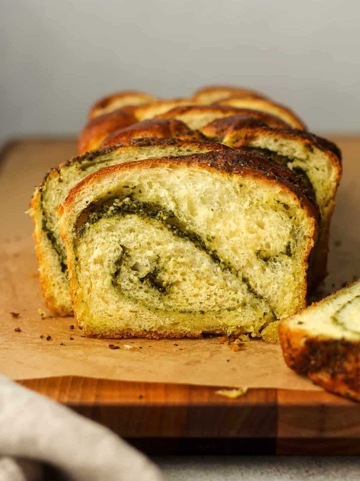 Side view of a board os sliced pesto bread.