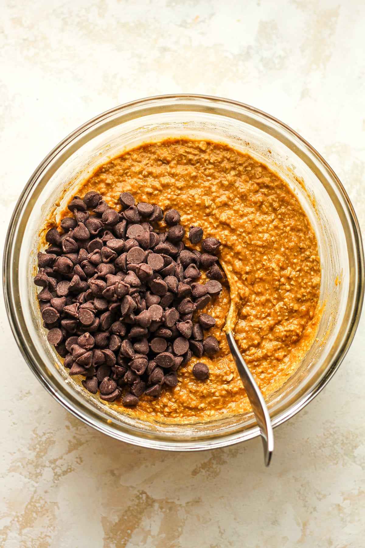 A bowl of the pumpkin muffin batter plus chocolate chips.