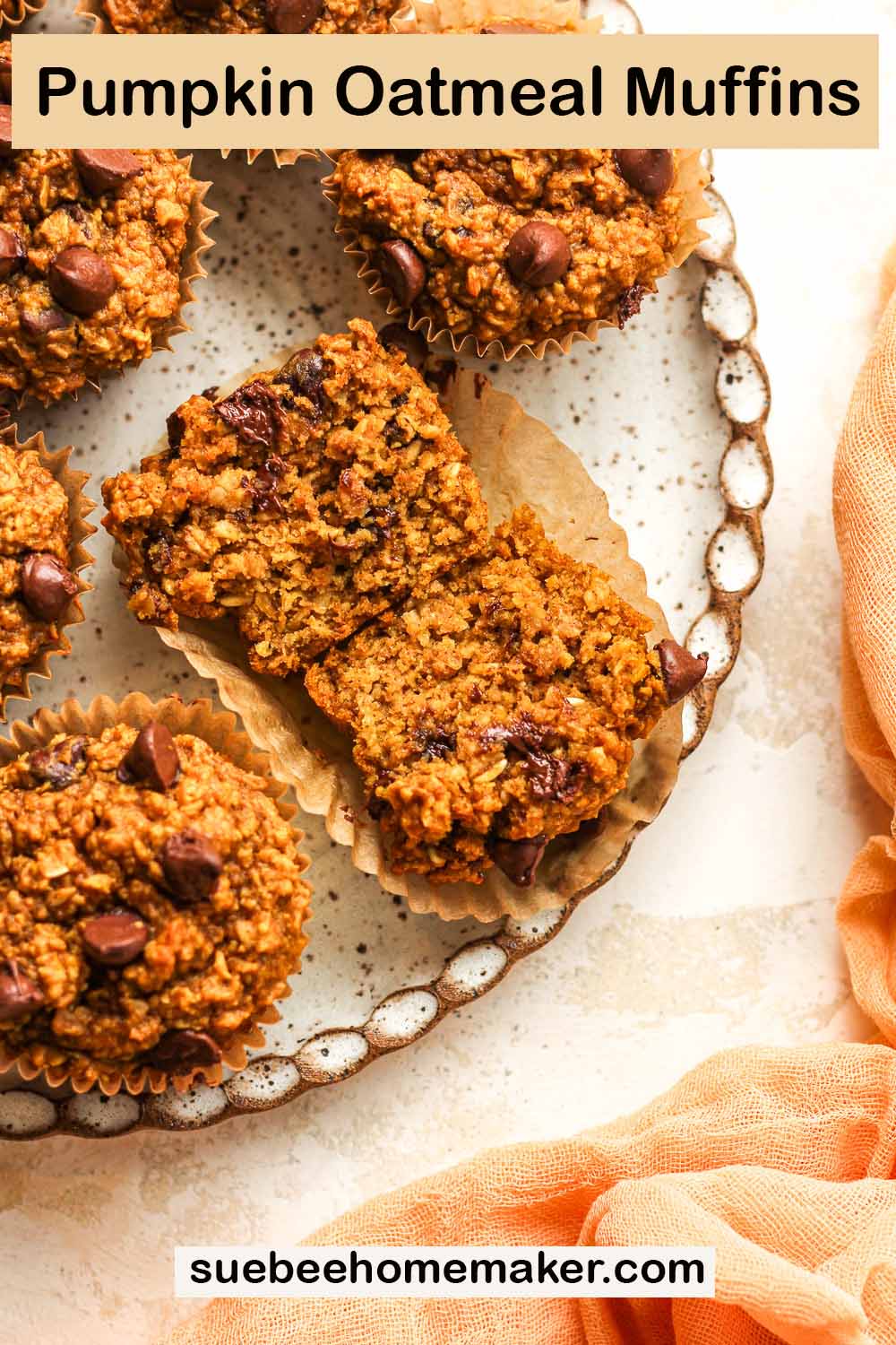 A halved pumpkin oatmeal muffin on a plate of muffins.