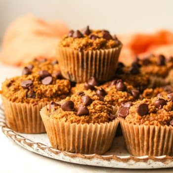 Side view of a plate of pumpkin muffins made with oat flour.