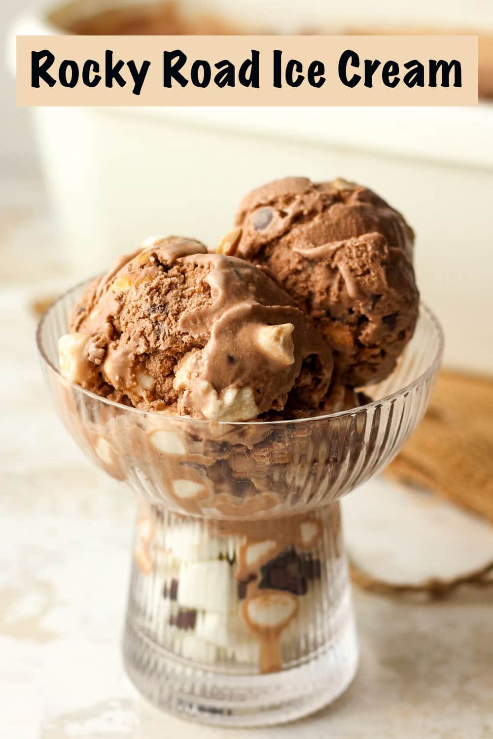 A glass dish of dips of rocky road ice cream.