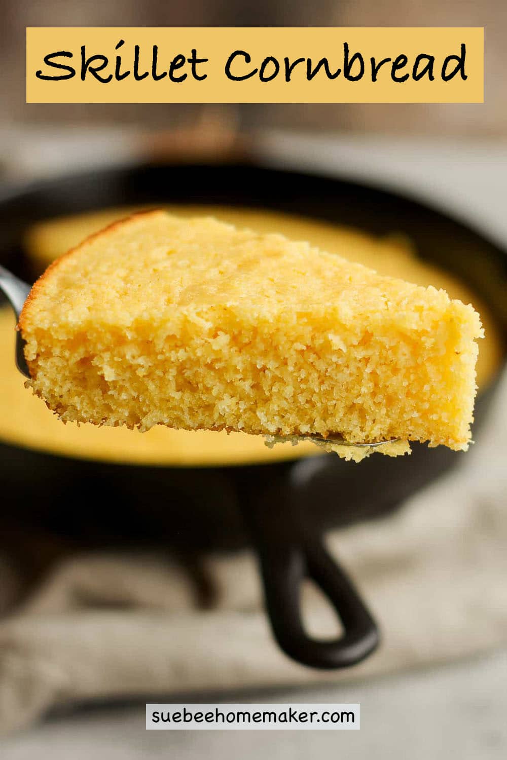 A spatula lifting up a slice of skillet cornbread.