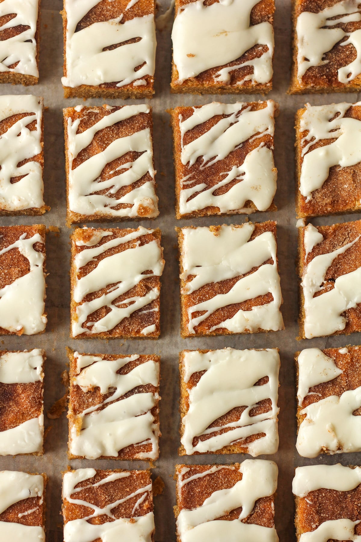 Overhead view of a board of 20 sliced snickerdoodle cookie bars.