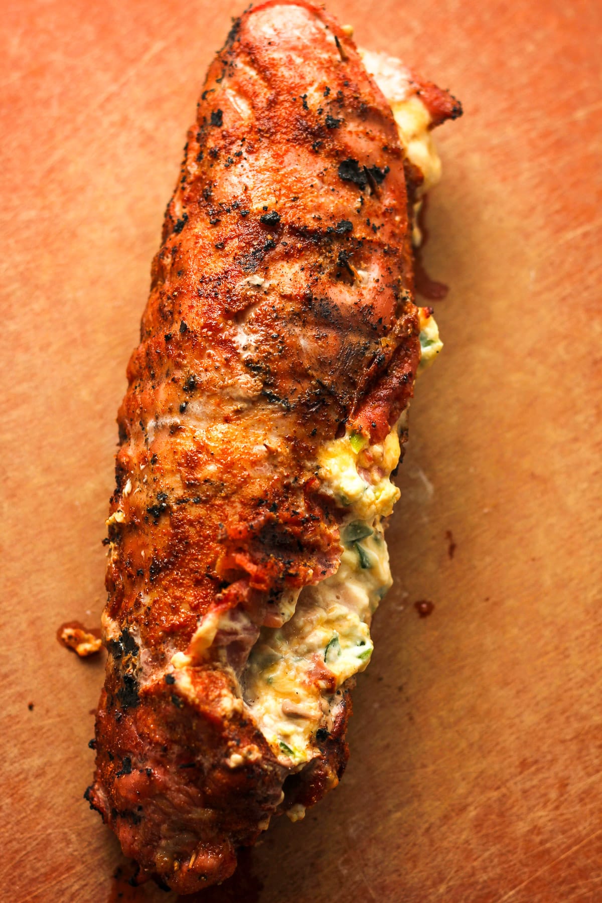 A stuffed pork tenderloin on a board.