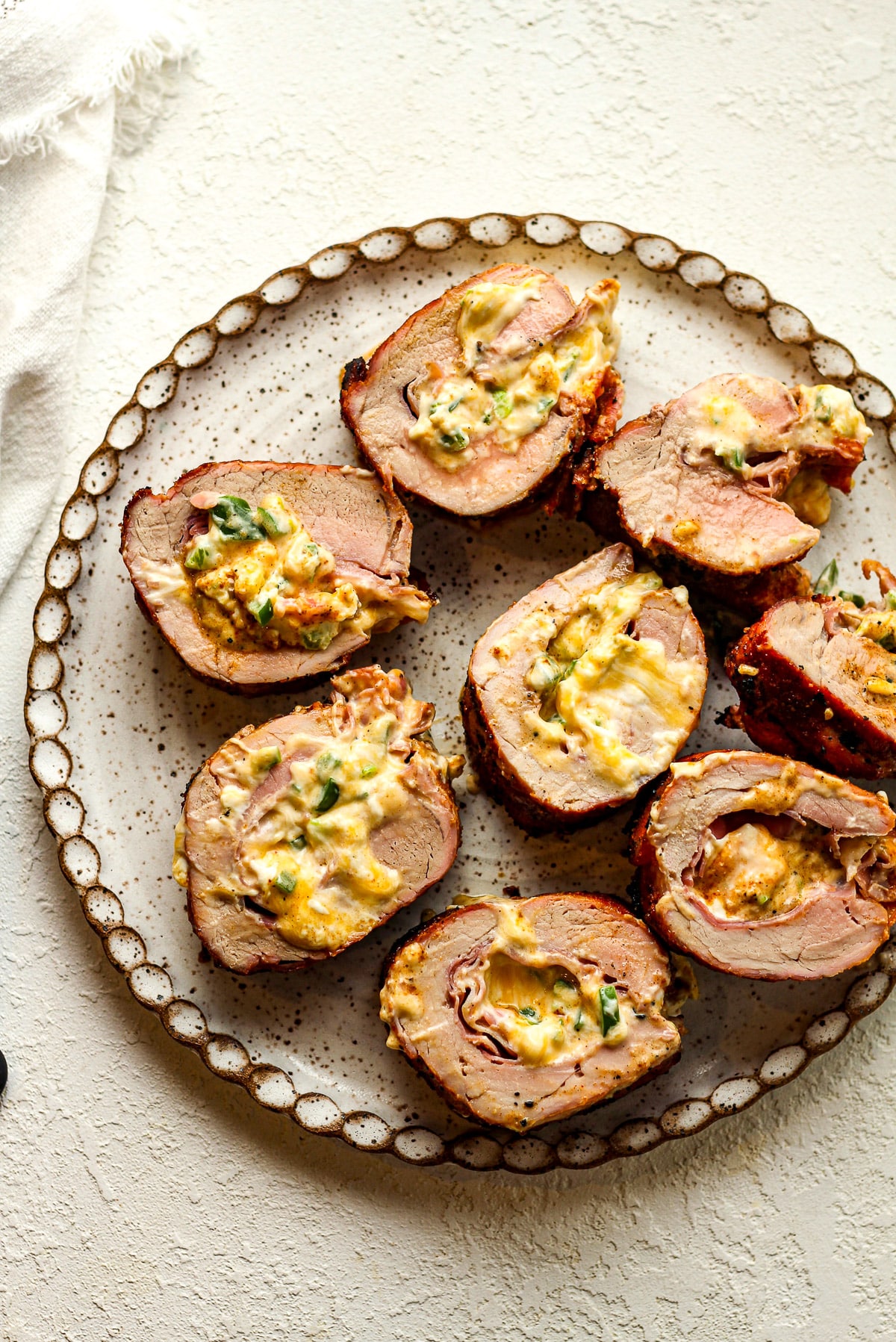 A plate of sliced stuffed pork tenderloin.