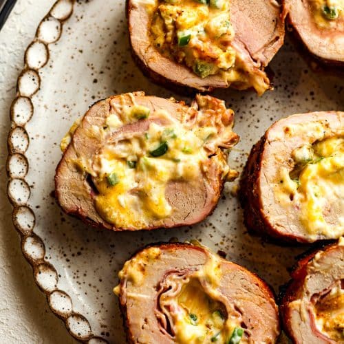 A plate of sliced stuffed pork tenderloin.