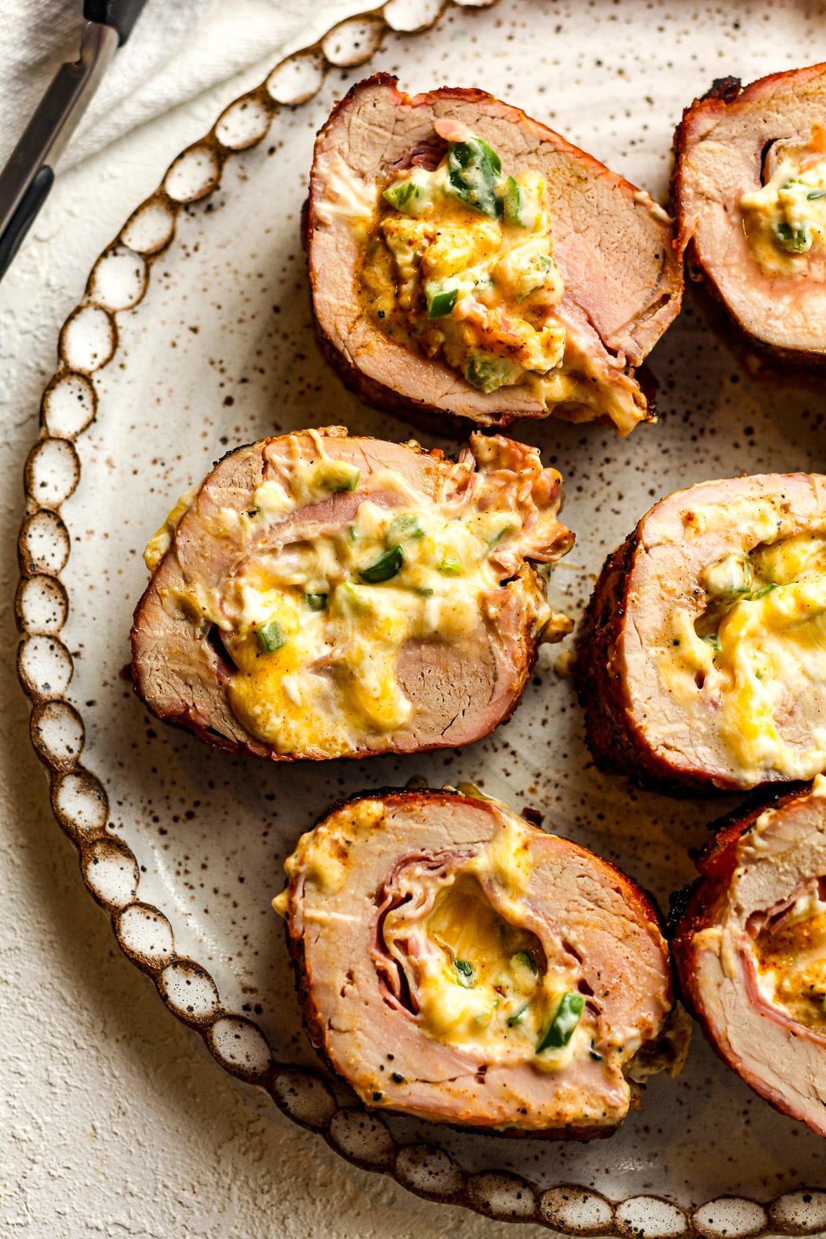 A plate of sliced stuffed pork tenderloin.