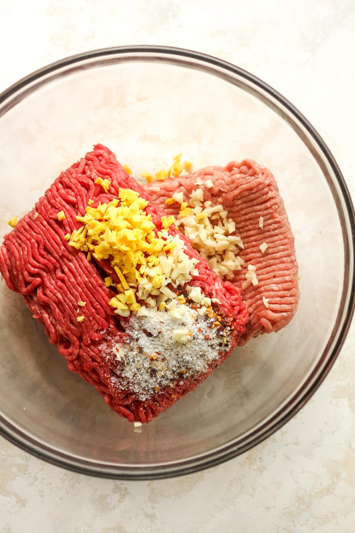 A bowl of the ground meats with ginger, garlic, and seasonings.