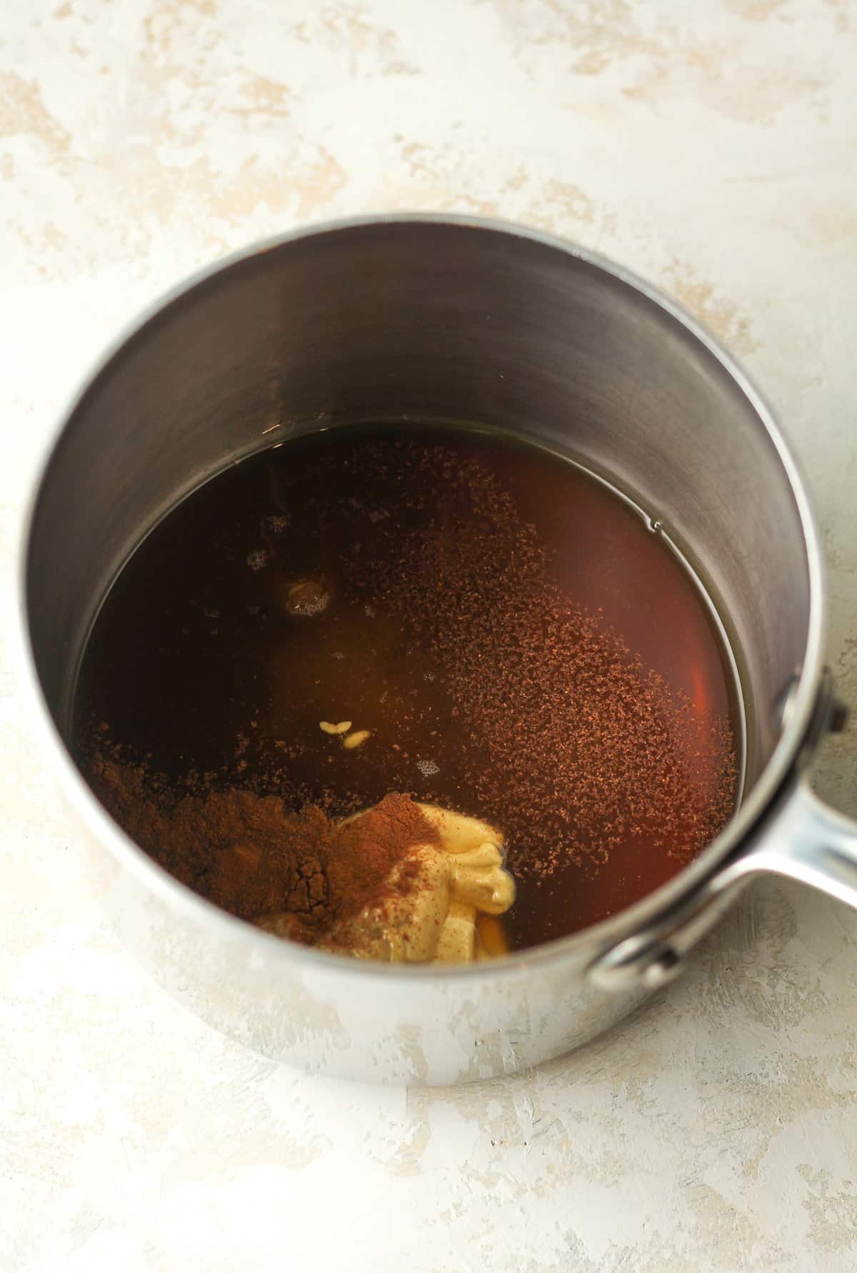 A pan of the maple glaze ingredients before cooking.