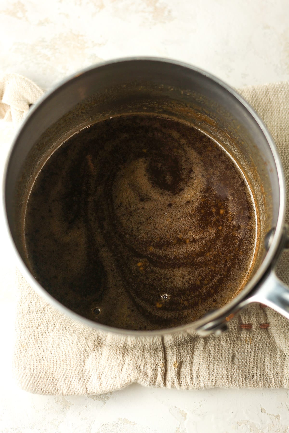 A pan of the simmered maple glaze.